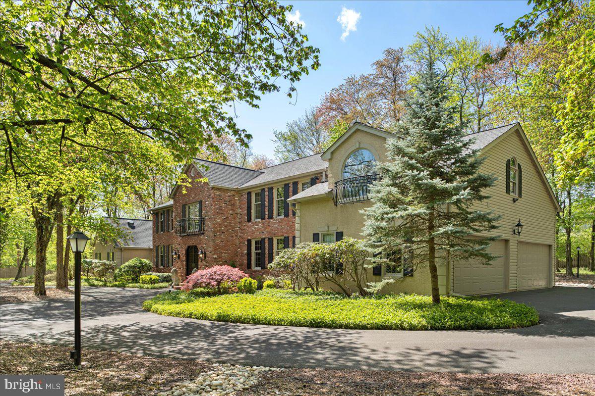 Welcome to 1980 Guinea Lane, an expansive multigenerational home featuring a separate in-law suite. As soon as you enter you will be able to appreciate the size and grandeur of this home that exceeds the photos. The circular driveway allows for plenty of parking, in addition to the two attached 2-car garages and the detached pole barn that can house up to 3 cars. The entire pole barn is heated and cooled with a heat pump and has its own electricity. It has gorgeous epoxy floors and a multipurpose living space upstairs. You could transform this space into an additional guest/in-law space, as it has a separate gated entrance and additional surveillance cameras.
Head inside the main house and you’ll be greeted by a grand foyer with two walk-in closets. There are many unique spaces throughout this home, including a great room currently being used as a music room with decorative fireplace. The library features built-ins and a herringbone floor, along with a wet bar. From there you’ll make your way to the billiards room with a wood burning fireplace and ample closet space. The large kitchen has tons of cabinet space, updated appliances, island, and a breakfast area. The dining room is large enough to fit a table seating up to 16 people. You’ll also find a charming sunroom and “trophy room” which would be perfect for an office or mudroom with all of its built-ins.
The sunroom leads to a hallway taking you to the cottage wing, which is perfect for an in-laws suite. It features a private entrance and doors to create privacy from the rest of the home. The cottage wing also has its own private driveway and two-car garage. An entertainment room with wood burning fireplace and a kitchenette allows for plenty of space to relax. Upstairs is a sitting room and bedroom with skylights that let natural light pour into the space. A full bathroom and laundry room are also found in this section of the house.
Back in the main house, there are 5 bedrooms upstairs. The primary suite has a walk-in closet and two bathrooms – one full and one half bathroom. Two of the other bedrooms share a full hall bathroom, and the other two bedrooms have access to a huge jack-and-jill bathroom/laundry room combination. One of the bedrooms has a private balcony with a fire escape leading down to the patio out back. The basement features a theater room, bar, office, sauna, wine cellar, and shuffleboard room – plenty of space to entertain!
The backyard has a nice patio and paths through the woods. Across the street is Guinea Park, and the home is close to restaurants, shopping, and commuter routes. This is the perfect home for large families or multiple families! Don’t miss your chance to see this stunning property, schedule a showing today!