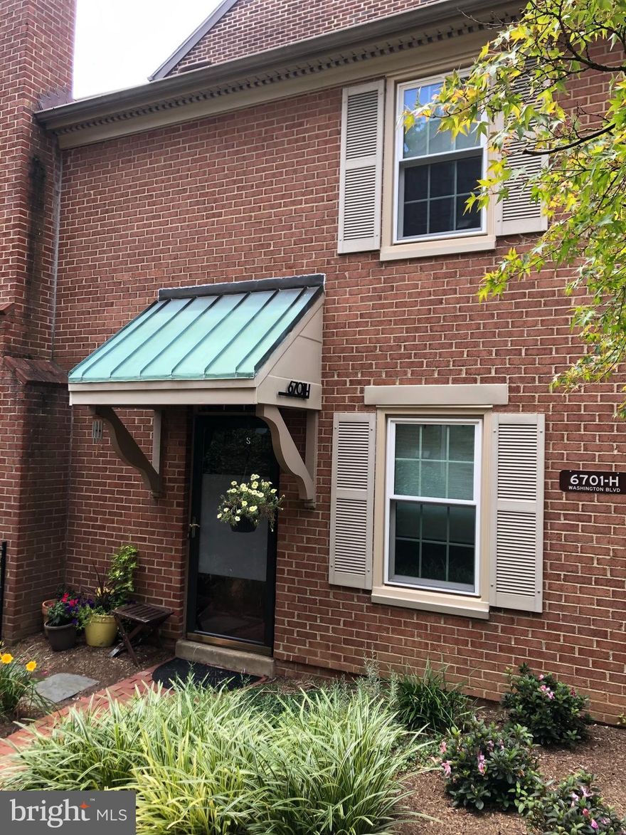 Charming brick townhouse-style condo available just steps from East Falls Church Metro!  This gem of a home offers both the convenience of easy transportation options while also enjoying a quiet neighborhood tucked back into the peaceful Laurel Mews enclave. The entrance  welcomes you with a  lovely landscaped front path  which leads to the front door or around to the brick-walled patio.  The main level is bright and inviting with an open floor plan that showcases the stunning kitchen area at the heart of the home.  The stylish kitchen features beautiful cabinets and countertops, stainless steel appliances, built-in seating and  leads to spacious living room with a propane fireplace and glass doors that open onto the large deck; a perfect flow for entertaining or enjoying al fresco dinners at home! A main level powder room is tucked away for added convenience. The upper level features two spacious bedrooms, an updated bath, and extra storage.   Come see this beautiful home today!