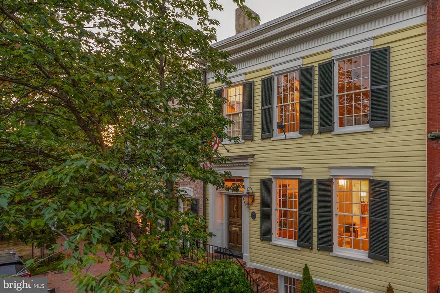 Two level expansive living in Old Town! This  rare, plaqued  Greek Revival was built in stages between 1790 and 1850. The original Flounder was expanded forward which history tells us was often the case as the owners' wealth allowed.  With 3,360 square feet on two levels this handsome classic has been carefully curated with respect for the past and for current living standards. Grandeur prevails beginning with the entry's gas lighting fixtures, German/ Dutch lap wood siding, hand crafted mahogany front door and the formal gallery foyer with a regal staircase. The 11.5  foot ceilings, exquisite crown moldings, chair railings and six remarkable fireplaces with mantels beyond compare are some of the unique features.  There is a double parlor with pocket doors, unusually large room sizes and original cylinder glass windows, The current caretakers have pristinely maintained and updated with exquisite craftsmanship of custom built-in's, a metal, standing seam roof and two laundries.  The expansive kitchen was added at the rear of the Flounder and in doing so a cistern was discovered! SEE DOCUMENTS in listing for more details on this- the City's historians were delighted. This smashing kitchen features a heated floor, a working fireplace and wet bar all custom designed.  There are four bedrooms and three full updated baths and laundry on the second level in two separate wings and below grade there is extensive storage  (apx 1,000 square feet)  with 2nd laundry- perfect for a wine cellar and a ping pong table.   There are six fireplaces- 4 are decorative (perhaps could be converted to gas) and the two wood burning are in good working order however convey as-is. The large and elegant, wrap around brick patio with fountains allows for a private retreat. With all said, this is not a museum- bring the family and pets. Located one block from King Street and in view of historic Christ Church- this is a modern day purist's dream.