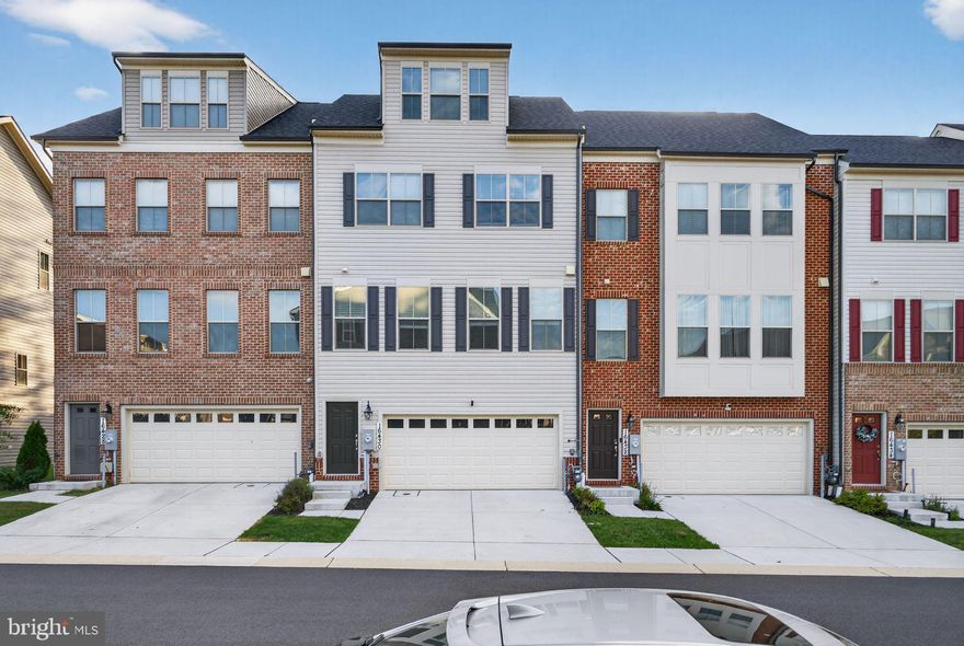 This less than 2 years 4-level townhome blends contemporary upgrades with thoughtful design, creating a bright, open feel throughout. Expanded front and rear bump-outs add extra space and natural light, while bedrooms are smartly distributed across three levels—including a private loft suite with full bath and rooftop deck. The walk-out lower level features its own bedroom, full bath, and access to a private patio, ideal for guests or multigenerational living. A sun-filled main level offers a generous deck for entertaining, and the two-car garage provides convenient parking and storage. Premium finishes and upgrades include an enhanced elevation, sunroom addition, coffered ceilings, crown molding, custom closet systems, and extra kitchen cabinetry for abundant storage. Gas heat and a gas cooktop make daily living efficient and chef-friendly. Stylish, spacious, and move-in ready—this home delivers comfort and flexibility at every turn.