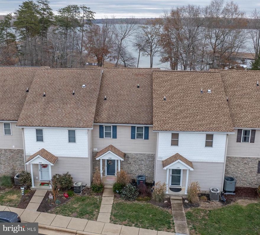 RARE OPPORTUNITY: improve your life with this completely furnished waterfront townhouse, includes newly constructed private boat slip with lift, jet ski pads, high speed fiber internet, tennis courts, sandy beach, and other valuable amenities, all on the public side of Lake Anna, at incredible location!  All boxes are checked, including the incredible price.  Just a one-minute walk to popular restaurants, the Lake Anna Taphouse, coffee shop, ice cream, Yacht Club and more.   Here, you'll experience true lakeside living and massive water views, without the million-dollar price tags and maintenance headaches that come with other waterfront homes.   This spacious two-level waterfront home features three large bedrooms, three bathrooms, and approximately 1,300 square feet.  Soak in beautiful water views from the comfort of your open living room with floor-to-ceiling windows and fireplace with mantle, all of which seamless ties into your updated kitchen with new stainless appliances, tile backsplash, and more, thoughtfully designed to showcase your water views from any spot on the first level.  Your first floor also includes a convenient laundry room closet and powder room.   On the second floor, your spacious primary bedroom features a private balcony overlooking Lake Anna, where you'll enjoy memorable sunrises and hot coffee; the primary bedroom also includes an en suite bathroom and closet.  Down the hall, your guests will enjoy two additional bedrooms, another full bathroom, and enjoy a large linen closet.   Unwind, grill dinner, and enjoy a cocktail on your back patio.  Park your boat and jet skis out back in your own private boat slip, at the recently constructed boat dock, directly behind your home.  Electric boat lift and jet ski pads included; boat and two jet skis offered for sale separately (watercraft details and pricing in documents section).   Walk to Vito's for lunch, grab fresh sushi for dinner at the Asian Cafe, or have a cocktail at the Lake Anna Taphouse under the stars to the sound of live music.  Waterfront living at Lake Anna does not get more convenient.   Many recent upgrades, including new HVAC (2022), new appliances (2021-2022), doors and windows (2024), water heater, and much more (see complete list of upgrades and improvements in documents section).  Home comes completely furnished.  Investors: short term rentals are permitted in this location.