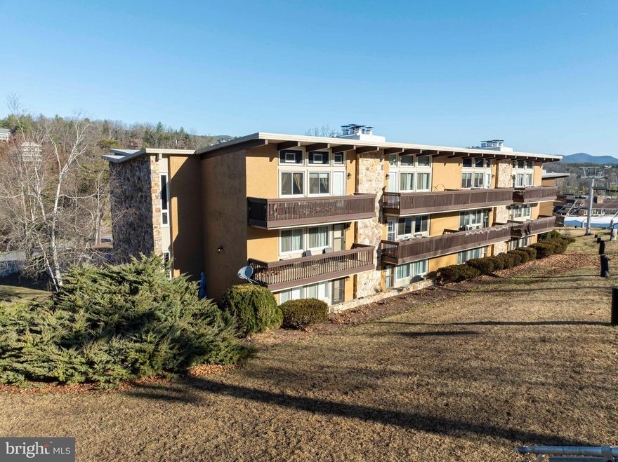 Whether you are seeking a seasonal retreat, a potential investment opportunity or a year-round residence, this is condo is your gateway to unforgettable experiences at Bryce Resort. 
Welcome to your ideal mountain getaway-a beautifully designed open floor plan condo located right next to the ski slopes at Bryce Resort. This property embodies the ultimate blend of adventure of relaxation, offering unparalleled access to both winter skiing and summer golfing.
Step outside the condo building  and you'll find yourself just off the slopes and ready to carve fresh tracks in the snow or enjoy a leisurely day in the breathtaking winter landscape. In the warmer months, you can jump on the back nine of Bryce's gorgeous golf course and walk a few holes.
Inside, you will love the charm of the stone, wood-burning fireplace that serves as the perfect gathering spot for friends and family after a day of outdoor activities. The spacious open floor plan provides versatility, allowing this area to function as one large room for entertaining or transforms in to two private spaces with the elegant original wooden accordion door. 
Imagine starting your day on the balcony, sipping your morning coffee or tea while soaking in the breathtaking views of the ski slopes as the sun rises above the mountain. 
This unit has not only provided memories for its owners but has also proven to be a successful short-term rental, making it an excellent investment opportunity.