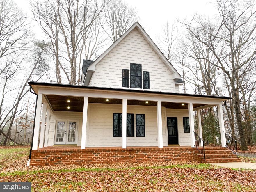 Charming and elegant farmhouse.  Turn onto the winding drive, step onto the brick porch and you will find yourself falling in love with this unique home. Enter through the beautiful front door and find gorgeous black hardwood floors, 9 foot ceilings,  a sunlight filled living room and a kitchen with bar eating, plenty of cabinet space, stainless steal appliances, a black farmhouse sink and quartz counters. A breakfast area, laundry room and master suite finish off the main floor living. The master bedroom is well sized and features hardwood floors, french doors leading to the porch, a walk in closet, an ensuite bath, double vanities,  ceramic tile and walk-in shower. Climb the staircase to two bedrooms, with closet space galore and a shared beautiful bathroom. The outdoor living could be your favorite part, with an additional 581 square feet of covered porch, featuring brick flooring and wood ceilings, just waiting for your porch swing or rockers. All sitting on 2+ beautiful wooded acres in a great location. MORE PICS COMING SOON.