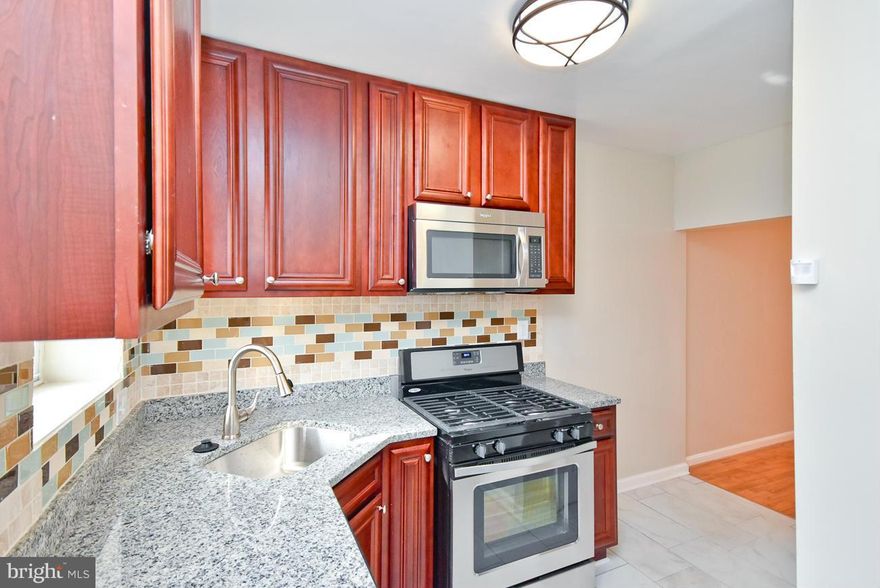 Tasteful AND affordable in HOT Washington Village. Fresh, nicely appointed rehab, featuring glimmering wood floors, exposed brick & ceramic.  Brand New Kitchen w/42   Cabinets & SS Appliances & Custom Back Splash.  large bedrooms, whirlpool tub, & a spacious first floor with powder room makes this home ideal for an owner occupant.