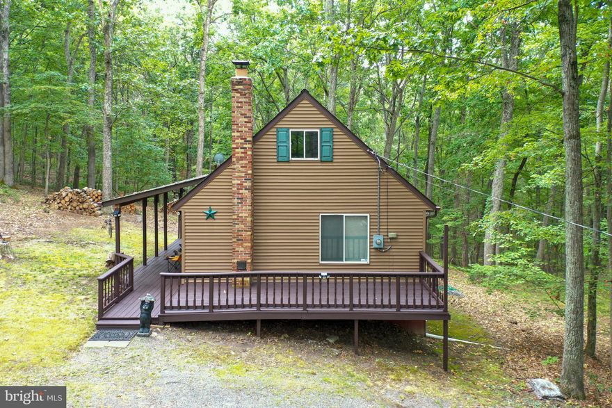 Welcome to 384 Rock Creek Trail, your very own cabin in the woods nestled on a sprawling 4+ Acre property comprised of two lots LOT 32 & 36 in SHORT MOUNTAIN VILLAGE. This enchanting mountain getaway offers the perfect retreat from the hustle and bustle of everyday life, providing a serene and tranquil atmosphere. Situated around 250 feet from 8000+ acres of public hunting land, this property is a dream come true for outdoor enthusiasts and nature lovers. A wet weather stream meanders through the property, adding to the allure and creating a soothing ambiance.The large windows allow an abundance of natural light to flood the rooms, offering breathtaking views of the surrounding forest.

Don't miss the chance to own this remarkable cabin in the woods, where tranquility and adventure await. Embrace the mountain lifestyle and create lasting memories.