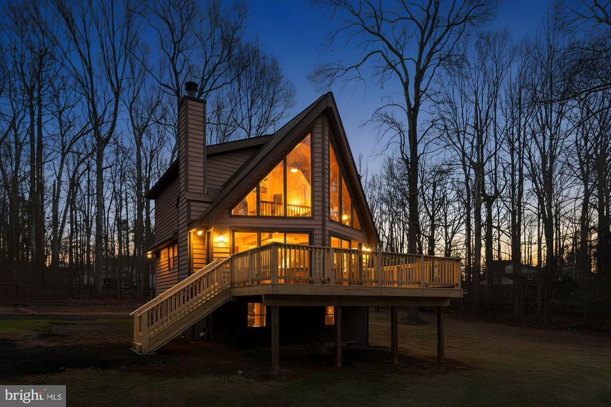 Step into a home where the boundary between architecture and nature dissolves. This striking Haymarket chalet, perched on a private 1.81-acre pastoral lot, is anchored by a breathtaking two-story great room with floor-to-ceiling windows that frame the shifting seasons like living art. A massive stone hearth stands as the centerpiece, with vaulted ceilings, impeccable craftsmanship, and a coveted mountain side view.

This home is designed for effortless living with three finished levels, each served by its own fully renovated, modern bathroom. A rare and sought-after main-level bedroom and full bath provide ultimate convenience for guests or multi-generational living. Retreat to the upper-level primary suite for total escapism, featuring a spa-inspired bath with a sculptural soaking tub and a private balcony for starlit evenings.

Enjoy complete peace of mind with extensive recent upgrades, including a 2016 roof,  Natural wood grain siding, oversized gutters, and three brand-New decks that offer seamless indoor-outdoor flow.  A refinished kitchen with stone counters and American pine wood trim. The mechanical systems are equally impressive, featuring a water heater and air handler, along with two propane tanks for consistent energy reliability. Updated plumbing and electrical wiring throughout the home.
 
Located on a private road with No HOA, this property includes a functional storage shed and a scenic private pond. Excellent potential for a short-term rental or vacation home. While you feel worlds away, backing to Bull Run Mountain and Evergreen Golf Course, you are only miles from the new premier Sprouts Heathcote Marketplace and downtown Haymarket. 
Community Activities include several prestigious golf courses located within miles of downtown Haymarket.
Outdoor recreation includes Silver Lake Park, James S. Long Regional Park, and various equestrian and hiking trails. Conveniently located near the Warrenton Training Center (WTC), US 15 connects north to Leesburg and south to Warrenton. Interstate 66 is the primary highway serving Haymarket. It extends westward to Interstate 81 near Front Royal, and eastward to Washington, D.C. This is more than a house; it’s a move-in-ready retreat for diverse living.