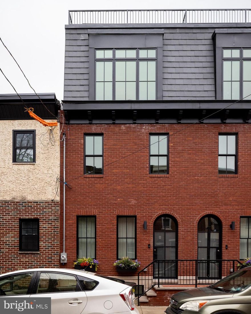 Introducing 1923 Montrose Street, an urban oasis in the heart of Philadelphia. This fully renovated, modern 4-bedroom, 3.5-bathroom home spans 2,730 finished square feet, and offers a luxurious retreat in a vibrant neighborhood. It’s conveniently located within walking distance to both the Schuylkill Banks and Rittenhouse Square, and within the Marian Anderson Elementary Catchment.

Step through an arched front steel door and rebuilt facade, into a very stylish living level that has a generous amount of space for lounging and dining, as well as a powder room and fabulous kitchen. The kitchen includes a long central island, bar area, thoughtfully designed cabinetry, and high end appliances. Seating along one side of the kitchen island is ideal for casual dining, food prep, and entertaining. In the rear of the first floor, glass doors provide fantastic daylight in the kitchen and lead outside to a private back patio.

Downstairs, the fully finished basement includes a media room/den, a full bathroom, and an additional bedroom, complete with heated floors for added comfort.

Ascending to the second floor, you’ll find two bedrooms with carefully designed closets, large windows, and a large full bath that includes a double vanity, soaking tub, and shower. A laundry closet equipped with a washer and dryer is conveniently located in the 2nd-floor hallway.

The third floor is dedicated to the primary owner's suite, and features a spacious bedroom, a large walk-in closet, and a remarkable wet room with a double vanity, stall shower, and a soaking tub. An additional room on the 3rd floor offers flexibility for an office or a quiet retreat. With an adjacent closet, this can also serve as a fifth bedroom.

Up the stairs to the roof level is an indoor wet bar that leads outside to an expansive outdoor roof deck with captivating views and the structural requirements and connections for a hot tub, creating the perfect setting for entertaining or unwinding.

The home is adorned with modern Moroccan notes and authentic materials such as Zia tile, Cle tile, white oak, cement tile, and Tadelakt treatment in the bathrooms, showcasing exquisite craftsmanship and attention to detail. Large windows provide abundant natural light in the home, and natural hardwood floors run throughout.

Located on a quiet, tree-lined street, this home is the epitome of urban sophistication. A fully rehabbed property with this much style and quality is a rare find, and it comes with a 10-Year Tax Abatement. It's no surprise that it was featured in The New York Times.  Don't miss the chance to make 1923 Montrose Street your urban sanctuary. Schedule a showing today!