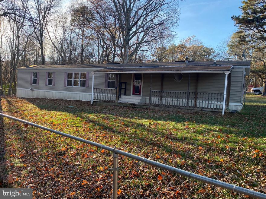 This newly renovated property features 3 bedrooms, 2 full baths and sits on a full acre of land! In the open living and dining rooms you have easy care laminate flooring and overhead light. An arched entryway leads into the kitchen with laminate, gas range and refrigerator. Down the call you have 2 generously sized, carpeted bedrooms. The hall bath features a single bowl vanity and tub/shower combo. The primary suite is also carpeted and includes 2 closets for double the storage. In your primary ensuite you have a double bowl vanity and lovely 5 ft tub/shower with ceramic tile surround. There is a mud/ laundry room with machines and shelving storage. Outside a portion of the acre is fenced and there is a large front porch to enjoy the views. Call for your showing now!