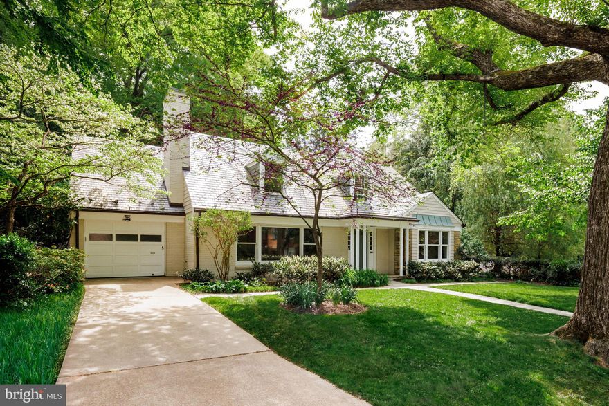 Proudly nestled in the heart of highly revered Kent, 5108 Macomb Street NW is a charming Cape Cod-style home, lovingly maintained and thoughtfully updated. Perfectly sited on its expansive 8,000 square foot lot, the home boasts striking curb appeal, highlighted by a manicured, level front lawn that evokes timeless images of classic American suburbia.
The façade features an elegant blend of brick, siding, and stacked stone, topped by a prominent slate roof with traditional dormers. A welcoming portico introduces the main entrance, which opens to reveal 3,800 square feet of well-designed living space.
The formal living room, extending over 20 feet in length, is located just off the entryway. Large picture windows bathe the space in natural light, while a wood-burning fireplace with a custom surround anchors the room. Flanking the entry are extensive wraparound built-ins, creating both function and charm.
A seamless flow leads to the formal dining room, where a discreet door provides direct access to the attached garage. French doors open to a stunning sunroom — a bright, cheerful space with direct access to the rear patio. The kitchen also connects to the patio and is equipped with a full suite of advanced stainless steel appliances.
Two generously sized bedrooms are tucked into a quiet main-level wing, sharing a centrally located hall bath.
Upstairs, the primary bedroom offers a cozy window alcove, a spacious walk-in closet, and a beautifully updated ensuite bath. A second bedroom on this level enjoys a large closet and access to a dedicated hall bath. A convenient laundry closet with stackable washer and dryer completes the upper floor.
The finished lower level, remodeled in 2023, features stylish vinyl flooring throughout. A spacious central recreation room connects to a full kitchen, a second laundry area with side-by-side machines, and a sleek, tiled full bath. A sliding barn door opens to a welcoming guest room, while a fifth bedroom suite includes a media alcove with glass mini fridge and private ensuite bath. A mudroom with walk-up outdoor access conceals the pool utility room.
Updated mechanical systems include two new sump pumps, advanced HVAC, and a full suite of smart security, surveillance, and exterior lighting systems.
A true highlight of the home is its outdoor space: an expansive stone patio surrounds the inground pool, while mature landscaping and substantial hardscaping create a private, peaceful oasis.
Thoughtfully updated, thoroughly livable, and ideally located, 5108 Macomb Street NW stands as a peerless example of Kent living at its finest.