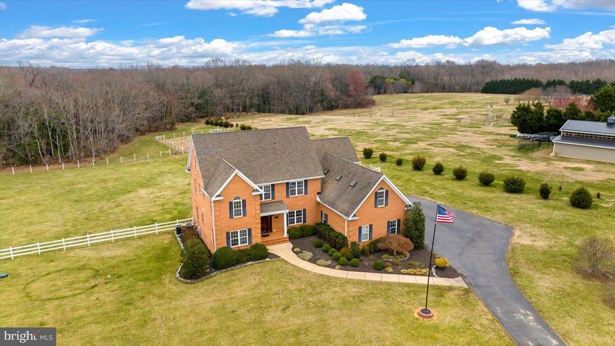 Experience the perfect blend of luxury, comfort, and tranquility in this stunning 4-bedroom, 4.5-bathroom estate, nestled on 10.71 acres in the prestigious Meadows of Dahlgren. As you step inside, you’ll be captivated by the gleaming, newly refinished hardwood floors, which flow throughout the main level, complemented by sophisticated crown molding, chair rail accents, and a striking double-sided fireplace that serves as a focal point in the family room and office. The formal dining room is perfect for hosting elegant dinners, while the private home office with an attached half bath provides a quiet retreat for work or study. The heart of the home is the gourmet kitchen, a chef’s dream featuring luxurious granite countertops, a gas cooktop, wall oven, dual dishwashers, and abundant cabinetry. The adjoining spacious family room overlooks the expansive backyard, offering breathtaking views and an inviting atmosphere for relaxation. Step outside onto the freshly refinished deck, an ideal space for outdoor entertaining or simply unwinding in the serenity of nature. Upstairs, the lavish primary suite is a private sanctuary, complete with a spacious sitting area, an attached bonus room, a walk-in closet, and a spa-like, newly remodeled ensuite bathroom. Each of the three generously sized bedrooms boasts an attached bathroom, ensuring privacy and convenience for family members and guests alike. The third-floor finished rec room provides endless possibilities—whether as a playroom, media center, or additional living space. This home has been meticulously maintained and thoughtfully upgraded, featuring brand-new plush carpet on the second and third levels, a new upstairs HVAC unit (2024) for ultimate climate control, a Generac generator with essential services panel, and dual tankless water heaters for endless hot water. Additionally, the septic tank and D-box were replaced in 2022, offering peace of mind for years to come. Perfectly located just minutes from Dahlgren, shopping, dining, and major commuter routes, this extraordinary home offers the perfect balance of elegance, modern convenience, and natural beauty. Don’t miss your chance to own this remarkable property!