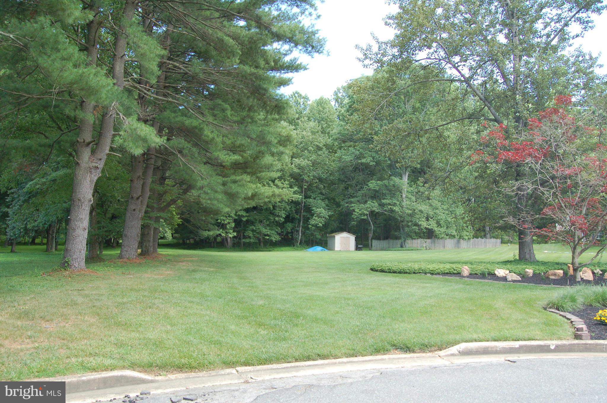 Large level building lot in established community. 1.58 acres located at end of Cul De Sac providing semi-private building envelop with a few mature trees. Approved & valid percs for septic. Seller will drill well with valid contract. Plat and tax map under Documents. Call for more info.
