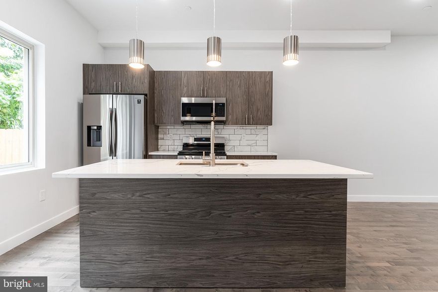 Boasting toasted oak hardwood flooring, fully-loaded kitchens, central air, and private outdoor spaces (hello, enormous patio), 1945 N 7th St #2 comes equipped with everything you need to feel right at home. Upon entry, you are greeted by an open living and dining concept. The room is soaked with sunlight thanks to the oversized windows. Whether you're a Grub Hub gazelle or a meal prep maniac, the kitchen offers stainless steel appliances, driftwood cabinets with brushed nickel hardware, calcutta quartz counter tops, and contemporary pendant lighting to support any culinary lifestyle needs. A half bath completes the first floor. Head downstairs to have your pick of two oversized bedrooms, each with their own full tiled bathroom and dedicated closet spaces. Washer/dryer in-unit. Recessed lighting throughout. Private intercom system and smart thermostat! $40 application fee per applicant. Generally, first, last, and security are due upon signing. $35 flat water fee per month. Pet-friendly. Walking distance to Temple University, Cousin's Supermarket, Human Robot Beer, Luna Cafe, the Broad Street Line. Easy access to all the happenings in Fishtown, Broad St/611, and Girard Ave. Available now.