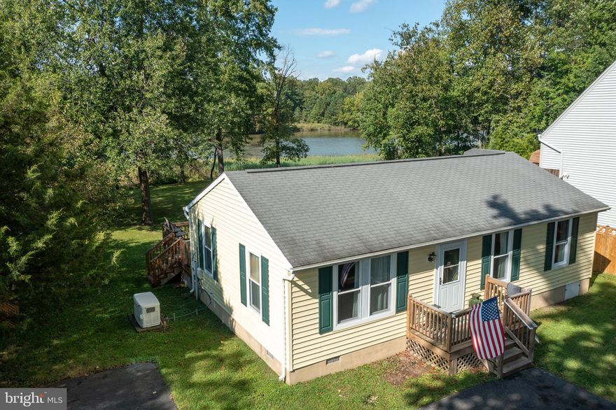 Non-riparian waterfront on Deep Cove Creek. Enjoy the beautiful serene water views from your deck. Eatin kitchen, spacious owners bedroom with full bath. Generac 10KW whole house generator. Community amenities includes two piers, playground, beach, boat club with Ramp and more.  Propane tank is owned by seller.