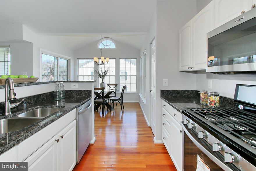 Spacious, welcoming & sunny, enjoy an open floor plan, separate LR & DR, wood floors, 1,244 sqft & balcony on the TOP floor. Features soaring ceilings, abundance of windows, 2 sided gas FP, new carpet & paint, updated kitchen: new granite counters & SS appliances, new MBA Silestone vanity top & flooring, 2012 H2O heater. Access to pool and playground. Near great shopping, dining & commuter routes.