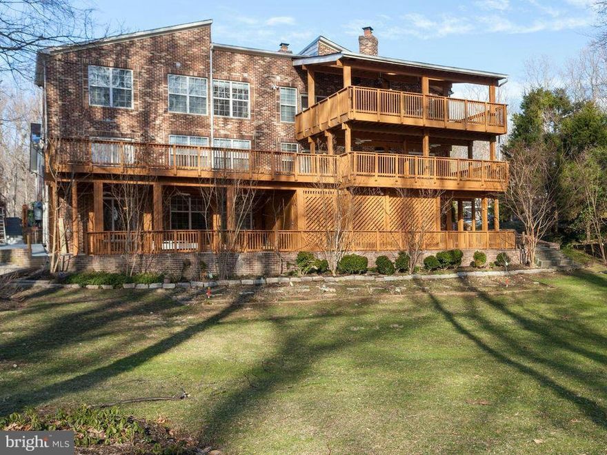 Extraordinary Three-level designed home in sought after Langley Oaks neighborhood.   Featuring 8 huge bedrooms,7 bathrooms, with over 7400 of living space, great for entertaining.  Stunning skylights, grmt kitchen w/ granite & cherrywood, hrdwd & marble flrs, huge  outdoor patio deck. Spectacular setting, overlooking huge yard, within minutes from downtown McLean, Tysons & DC.