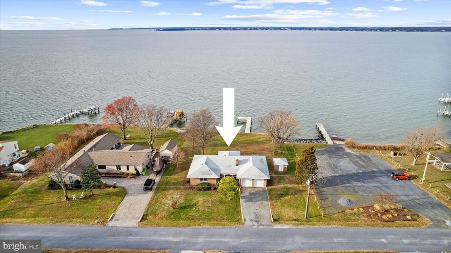 Discover a true waterfront treasure on .54 acres with 110 feet of waterfront. This beautifully renovated 3-bedroom, 2.5 bath home offers an open-concept layout design to capture breathing taking water views that stretch endless across the horizon. Each evening brings magnificent, direct sunset views-- the kind that make you stop, breathe, and take it all in. New pier in 2020! Step inside to luxury plank flooring that flows throughout the home, complementing a bright, modern kitchen outfitted with brilliant white quartz countertops, all new stainless steel appliances, abundant white cabinetry, and generous workspace ideal for cooking and entertaining. The refined design continues into each bathroom, where matching quartz countertops and coordinated cabinetry create a polished, cohesive aesthetic. With its expansive lot, serene waterfront setting, and elegant interior updates, this is a rare opportunity to own a home that blends comfort, beauty, and unforgettable views.