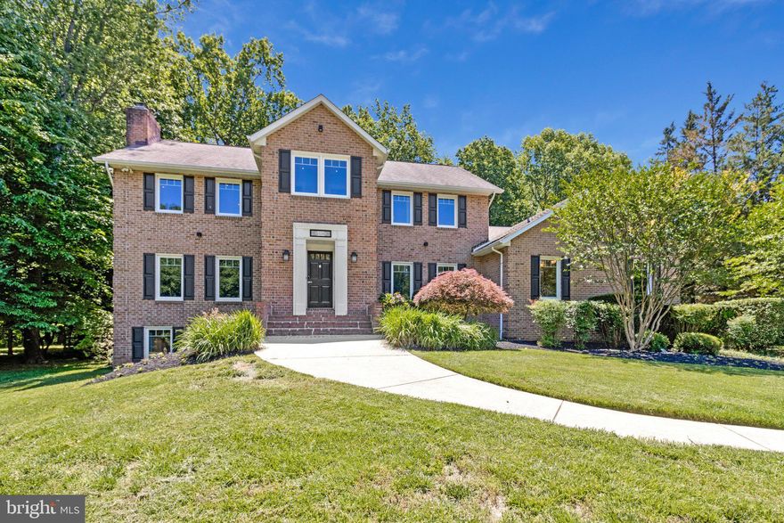 Welcome to this breathtaking all-brick custom colonial nestled in the coveted Highland Lakes community. Perfectly positioned on a serene, professionally landscaped 1.08-acre cul-de-sac lot backing to mature trees, this exceptional estate offers a rare blend of timeless elegance, modern comfort, and forward-thinking sustainability. Inside, an expansive open floor plan showcases gleaming hardwood floors, striking crown moldings, soaring 9’+ ceilings, and beautifully renovated finishes throughout. Designed for both grand entertaining and everyday living, the main level features a massive great room with beamed ceilings, an entry-level bedroom with a private ensuite, and an entertainer’s dream kitchen complete with dual sinks, two refrigerators, two dishwashers, an induction cooktop, double wall ovens, a wet bar, and a sun-filled breakfast area. The newly added four-season sunroom seamlessly blends indoor comfort with the beauty of the surrounding landscape. Step outside to your own private backyard retreat featuring an automated saltwater pool, scenic wooded views, and a low-maintenance composite deck perfect for entertaining. The home is also future-ready with a Tesla solar roof, dual Tesla Powerwalls for backup power, and a dedicated EV charging port in the garage. Upstairs, the luxurious primary suite offers spacious custom closets and beautifully updated spa-like baths. The fully finished lower level includes a complete in-law apartment with independent ground-level walkout access, ideal for multi-generational living, guests, or an au pair suite. Laundry is conveniently located on every level of the home. Beyond the property itself, this home offers the rare opportunity to own in one of Maryland’s most sought-after locations. With low annual HOA fees, easy access to both Baltimore and Washington, D.C., and a tranquil park-like setting, this thoughtfully renovated residence offers an exceptional place to call home. Adding even more appeal, the home is zoned for the highly acclaimed Howard County Public School System, feeding into Dayton Oaks Elementary, Lime Kiln Middle School, and the top-rated River Hill High School.