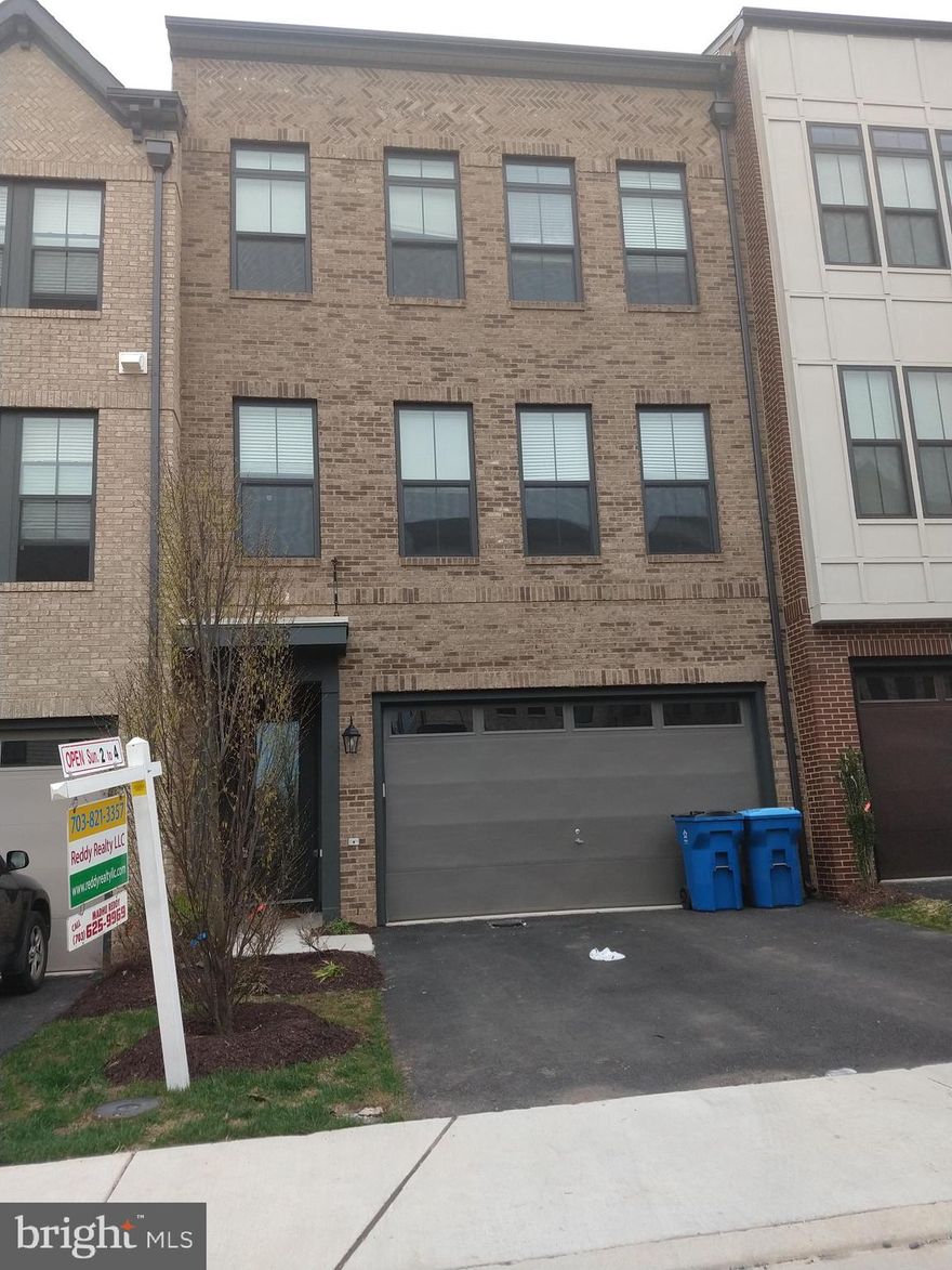 Vanmetre Parker  MODERN 3-LEVEL   BRICK TOWNHOME at Brambleton Town Center.  3,150 square feet! Main level features  gourmet kitchen with  Extended  QUARTZ island,  oven, gas stove top, and   built-in cabinets. Main level has high ceilings, large windows on two sides, walk out to Deck, hardwood floors and half bath.  Upper Level Lavish owners suite with enormous walk-in closet, and Master Bath with double sink vanity. TuB, Shower, Windowhis level has two additional spacious bedrooms, with shared Bathroom.  Lower Level Attached 2 car garage, Nice covered entry area with beautiful  tile walking in to the first floor rec room, Bed room, Full Bath. .  . This home  a must see