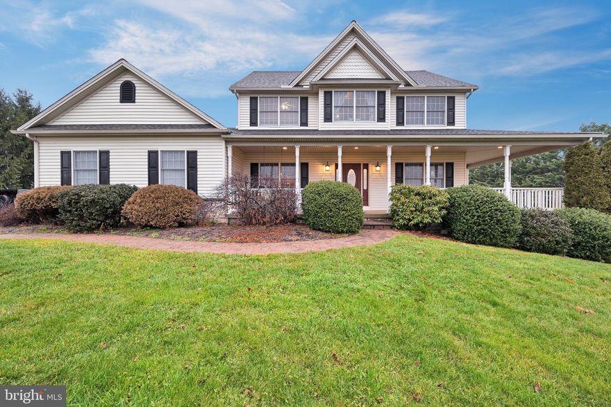 Looking for a true *forever home*?  The photos don't lie!  This custom-built home has been maintained beautifully, to include a brand new roof!  The curb appeal of this Colonial farmhouse on a full acre lot is great, featuring mature landscaping and a deep wrap-around covered porch with a swing.  On the first floor, you'll love the hardwood floors, wood-burning fireplace, custom mouldings and built-ins, and access to the phenomenal back deck and views!  As far as rooms go, there's a 1st floor bedroom or home office with a walk-in closet, a kitchen with all the bells and whistles, a family room with fireplace, a separate dining room, a half bath, and did I mention the deck?!  With access from the dining area, the deck and covered patio look out over the fenced backyard.  While trees on both sides of the lot provide for maximum privacy, the views from this area are just beautiful.  You'll spend a lot of time out here, rain or shine, I promise!  From the kitchen, there are a mudroom area and a laundry room (with a rough-in for a dog wash station!) on the way to the 3-car sideload garage.  On the second floor, you'll find a true primary suite, as well as 2 additional beds and a 2nd full bath.  All bedrooms feature vaulted ceilings, and there's a perfect window seat, with cedar storage, at the top of the stairs.  There are so many custom features in this home!  If you think you might need more space, just follow me down to the lower level.  This level walks out to the rear yard and has been finished with comfort in mind!  This large flexible space features a wet bar, another half bath, spaces for entertaining, gaming, and exercising, a pellet stove to keep it extra cozy, and also some thoughtful storage areas.  It could easily become your favorite place to hang out, or it could become an in-law's quarters, should you need that in the future.   Call your Realtor to schedule your private showing NOW!