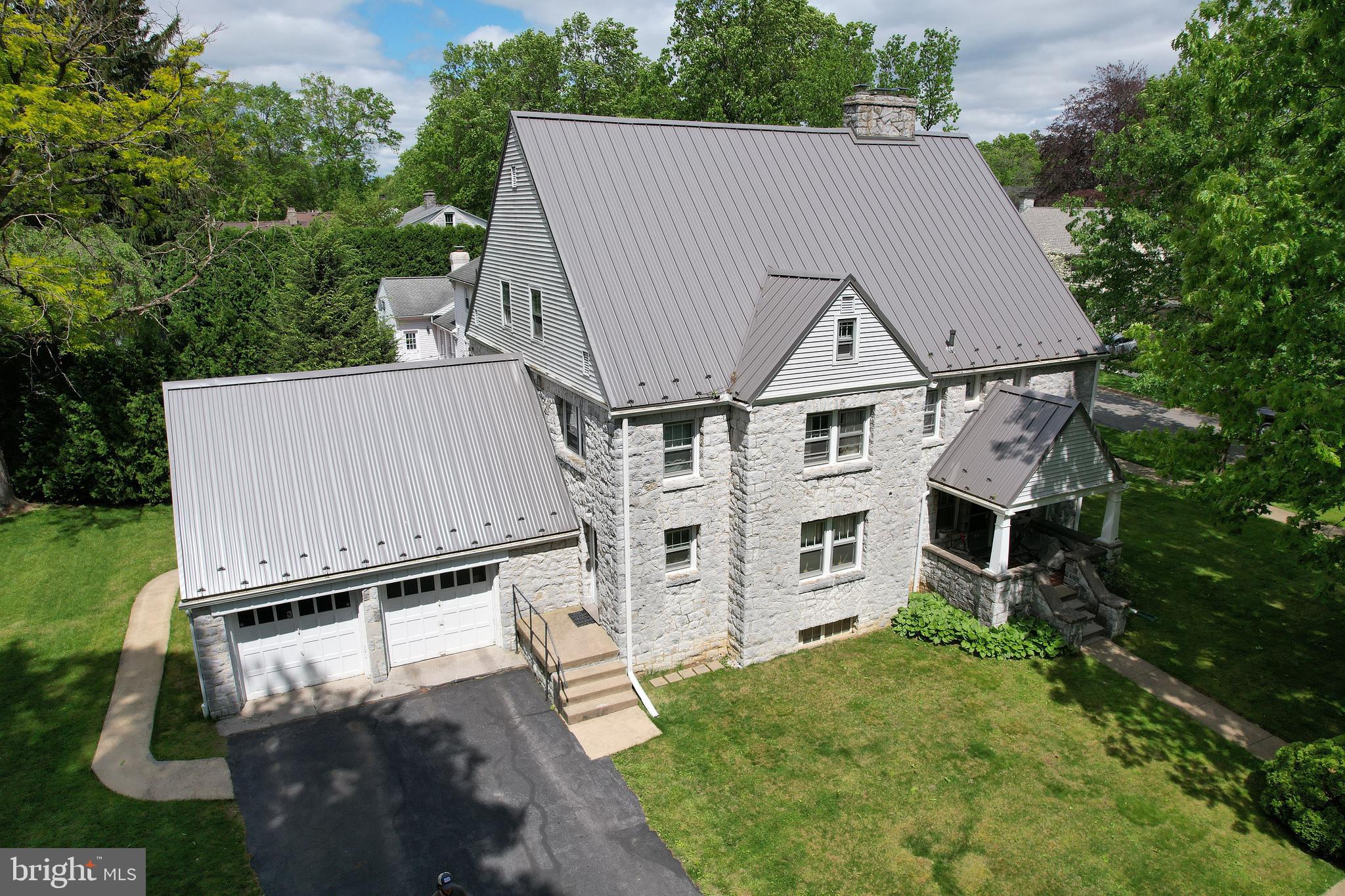 Only once every few decades does an opportunity like this come along ... This is your chance to own and reinvent a cornerstone plot of historic College Heights. Bring your inspirations, this 4100 Sq foot, 6 bed, 4.5 bath historic home, currently living as a duplex, is just waiting for your vision and restoration. Designed by Walter McCormick in the 1930's the house is all locally sourced limestone that was hand chiseled by a team of Italian Stone Masons and is situated grandly on a lovely 1/3 acre corner lot. You'll feel the nostalgia of a by-gone era the moment you enter from the crystal doorknobs to the original wood work. Significant remodeling is needed to bring this fabulous home back to the dazzle of its heyday. Just imagine the full walk-up attic with vaulted ceilings finished out as a swanky party room or art studio or let your mind picture Saturday mornings making blueberry pancakes before donning your PSU attire and heading to the stadium for noon kickoff. As a duplex, this home allows for three unrelated in each side and could serve well as an investment, full time home, or a combination thereof. The option for opening the walls to create one large house could allow for a fabulous manse for hosting guests galore. You'll appreciate the newer metal roof and solid construction. Each side features 3 bedrooms and 2 full vintage baths - an additional half bath is located on the left side first floor. Simple kitchens, one with a retro sewing nook and formal dining rooms feature on both sides. Full basements for storage and laundry are also accessible and there is an attached 2 car garage for the property. Tucked in a quiet, established neighborhood just a few blocks from the Nittany Lion Inn and one block to the Golf Course, this location can't be beat. Come take a look to spark your creativity and captivate your imagination of all this spectacular historic home could be!