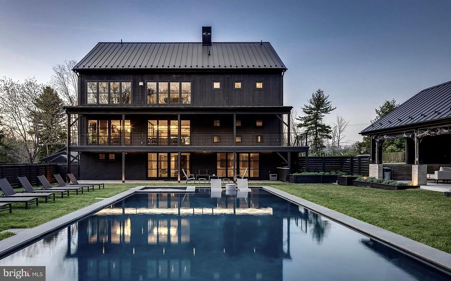 Just minutes from the heart of the charming river town of New Hope, PA , this breathtaking 10,000-square-foot estate on over 10 private acres offers an extraordinary opportunity to create your dream lifestyle. This new luxury property is a seamless fusion of modern design and luxury amenities. The property is meticulously crafted in collaboration with PASTELLA | BURNS, an international award-winning luxury home design/build firm. Seamlessly blending modern innovation with timeless design, the residence and its accompanying structures are purpose-built for both grand entertaining and everyday comfort. The main residence is a masterclass in luxury and functionality, featuring four expansive levels serviced by a glass-enclosed floating staircase and elevator. Vaulted ceilings create a dramatic sense of scale, while thoughtfully integrated LOXONE smart technology brings cutting-edge convenience. The primary living space is compiled of interlocking compelling spaces. Chic living and dining spaces, a spectacular bar, and glass enclosed 900-bottle wine cellar flow effortlessly to terraces and balconies and premier Bucks County landscape. The chef’s kitchen is complete with a custom La Canche range, Sub-Zero refrigeration, Miele appliances, and handcrafted Plato cabinetry. The island comfortably seats eight and is ideal for conversation over a lovely meal with the chef. With 8 en-suite bedrooms, the home offers a private retreat for every resident or guest. The top floor's movie theater and game room provide endless entertainment options, while the lower level includes a second chef’s kitchen tailored for hosting events and there is room for staff. The outdoor spaces are equally captivating. The centerpiece is a sleek salt water pool and spa. A 1,300sf Event Pavilion is complete with a lounging and dining area, convivial bar, a suspended fireplace imported from France, and a fully stocked outdoor kitchen featuring a pizza oven, hibachi tables, and a custom smoker. The Pavilion transforms every occasion into an unforgettable experience. Additional structures include a charming Guest Cottage, offering serene accommodations, and a bi-level, 1,600-square-foot Carriage House with a fitness center/dance studio, loft office, and full kitchen and bath. The property’s endless versatility makes this property perfect for serene country retreat to invite family and friends. Located just a short drive from New Hope’s renowned restaurants, boutiques, and cultural attractions, this property presents an unmatched opportunity to combine sophisticated living with small-town charm. The property is within an hour of Philadelphia and 90 minutes of Manhattan.