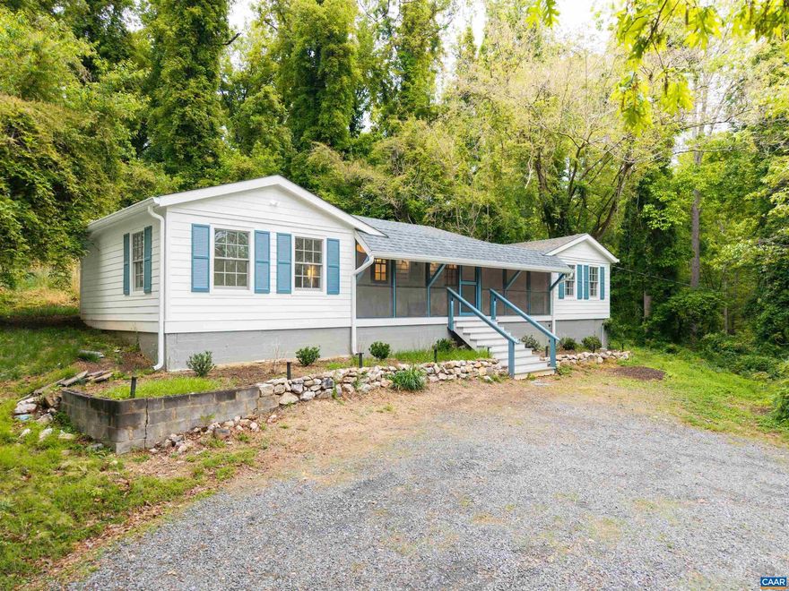 Serenity meets convenience at this freshly renovated Charlottesville home. Located just 20 minutes from UVA and Crozet, walking distance to Knight's Gambit Vineyard, and situated across the street from the Lake Albemarle boat launch. The location speaks for itself.  Built in 1930, this 2-bed, 2-bath cottage retains its original character, solid bones, and secluded feel on a wooded lot. Major updates just completed include: new roof, AC, siding, wall insulation throughout and a spacious 3 season screened-in porch. Fresh kitchen and bath renovations give the home a modern feel, never stripped of the charm.  Quiet by design with no boat gas motors allowed, Lake Albemarle offers year-round fishing for bass, bluegill, and catfish. You can be out on the water at first light and back on your porch for coffee before dawn.  Whether you're an angler seeking private access, a buyer looking for a wooded retreat with privacy just a short drive from town, or ready to rent out one or both bedrooms and let the property work for you, this home delivers!