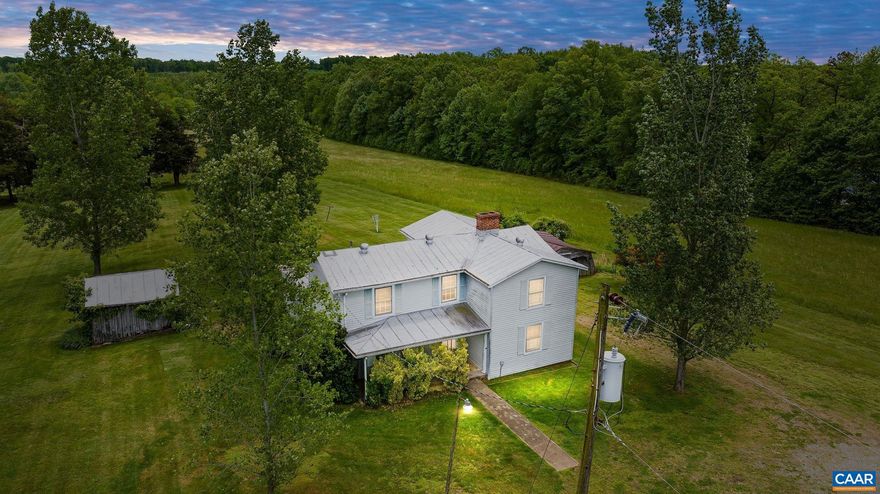 If you've ever dreamed of completely renovating the perfect classic farmhouse, located on a picturesque 4.89 acres, then this is the one for you!  The home was built in approx. 1920 and features 2,190 sqft. with three bedrooms, one full bath, and a half bath. Spacious kitchen with a center island. Windows galore to frame the pastoral views in every direction. Classic metal roof and a full front porch! There are 2 mini-splits for AC, and heat is a wall unit run on propane. Original hardwood floors throughout most of the home. Stately brick fireplace (not in use). The full bath is located on the second floor, with the half bath sharing the first floor/laundry area. Water is town water, and then a septic system. Two outbuildings on the property, enter at your own risk!! Property is being sold STRICKLY AS-IS with the sellers to make no repairs. This is a TRUE fixer-upper! Cash or REHAB loans only!,Wood Cabinets,Fireplace in Family Room