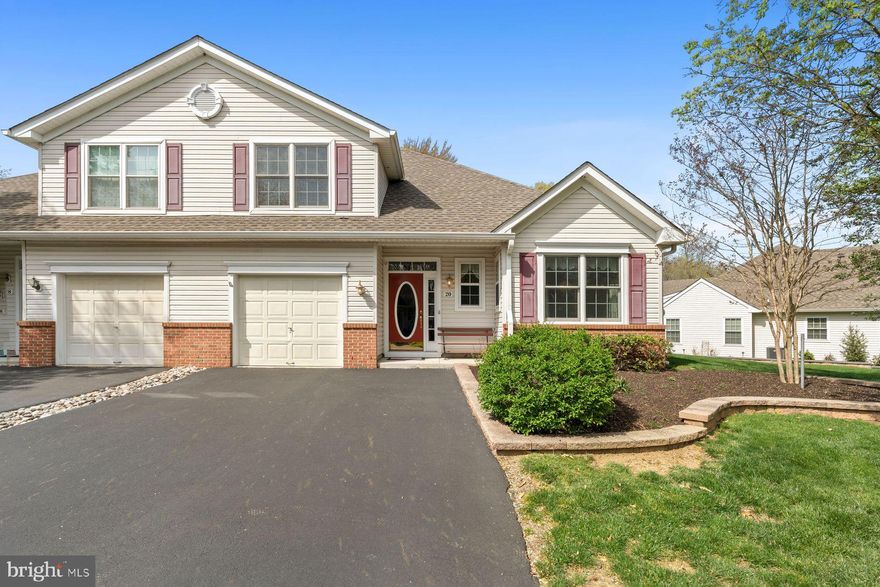 Offered for the first time by its original owners, this meticulously maintained Curtis model showcases pride of ownership and offers low-maintenance living with privacy in the desirable 55+ community of Flowers Mill. Backing to peaceful woods, the home features bright, open living spaces, including a spacious kitchen with granite countertops, abundant cabinetry, pantry, and a casual dining area designed for everyday comfort and easy entertaining. The main living and dining areas flow effortlessly into a versatile sunroom, ideal for a home office or sitting area, with access to the home’s exceptional 425 sq. ft. bluestone patio with electric awning and side yard perfect for outdoor dining, entertaining, or simply enjoying the wooded backdrop. The first-floor primary suite features generous closet space and a private bath with walk in shower, while a powder room, laundry area, and garage access add everyday convenience to this level. Upstairs offers a spacious guest bedroom, full bath with tub, and ample storage. Residents enjoy resort-style amenities including indoor and outdoor pools, pickleball, tennis, bocce, fitness center, walking paths, fishing pond, clubhouse activities, and easy access to shopping, dining, and major commuter routes.