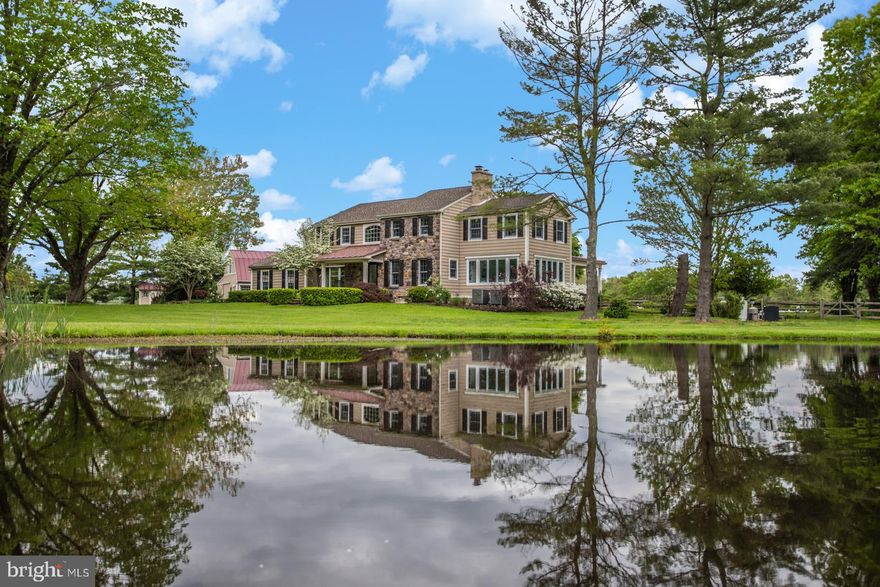 Experience luxury and comfort at Windy Bush Farm on 10+ acres of land. The secluded farmland offers a private serenity set back from the country road and overlooking the lush grounds and pond. The home has been thoughtfully refreshed and renovated to include beautifully refinished hardwood floors and crown molding throughout. The open floor plan is bright and modern offering a Mudroom, Study with a stone fireplace, Sunroom with walls of windows and access to covered terrace and Great Room highlighting a gas fireplace with custom mantel. Walk out French doors to a stone patio perfect for al fresco dining alongside a refreshing pool with a waterfall and spa. The gourmet Kitchen is a chef s dream with a large custom island, Quartzite counters, marble herringbone backsplash, subzero refrigerator,   seamlessly flowing into the breakfast area with vaulted ceilings, built-in window seating and French doors to the stone patio, creating an amazing space for elegant or casual dining that is perfect for any size gathering. Upstairs you will find the expansive main suite complete with a walk-in closet, sitting area with a marble fireplace and a bathroom that is ready to pamper with a jacuzzi tub, heated floors and his and her vanities. Completing the upstairs level are 3 additional spacious bedrooms which includes a suite with full Bath, and 1 full hall bath with dual vanities. The newly finished lower level provides additional storage, a gym and entertainment area. Additional amenities include an attached 2 car garage and a detached loft with an additional 2 car garage, new HVAC systems, designer light fixtures, closet organizers, perennial wildflower meadow. This home is in the exceptional Solebury school district and just minutes from downtown New Hope, Newtown and major roadways for commuting access.