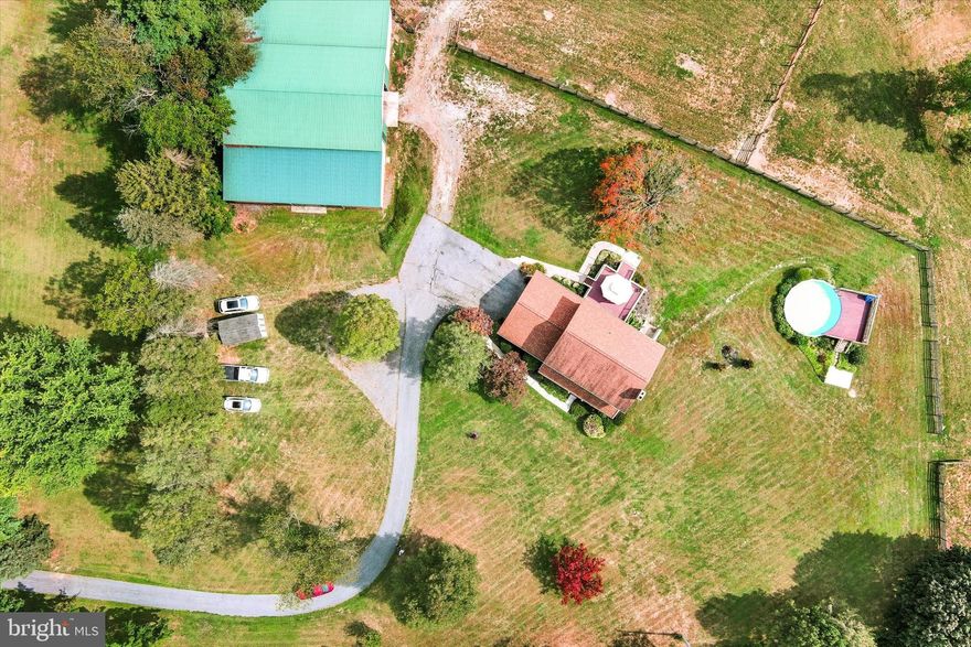 Fully Renovated Home on 14.85 Acres ** 64 x 86 Machine Shed/Barn  ** 3 Pastures ** Big Pipe Creek and a  Pool & Party Area.  Welcome to this beautifully renovated 4-bedroom, 2.5-bath home set on nearly 15 acres where your country living dreams can come true. The 2023 kitchen renovation features 42-inch cabinets, a large granite island, Stainless Steel Appliances, extra oven, deluxe gas range with hood and panoramic views from the kitchen, dining room, and deck. New neutral carpet and fresh paint  in the bedrooms. LVP flooring on the main level adds style and durability, while a walk-out basement awaits your personal touch. All major mechanicals have been updated, giving you peace of mind. Outdoors, enjoy updated composite decks,  above-ground pool, and children’s play area, perfect for entertaining or relaxing. The property includes three pastures, one with direct access to Big Pipe Creek, and a 64x86 barn with updated lighting, ideal for livestock, equipment, or even a business venture. The lower pasture is suitable for riding or grazing and has access to the creek. The front porch, framed by mature landscaping, offers the perfect spot for morning coffee and quiet evenings. Cable-ready and designed for modern living, this home offers the best of both worlds: a fully updated interior and the privacy, space, and freedom of country living.