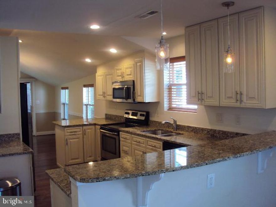 OPEN HOUSE SUNDAY 11/3 FROM 12-2  Home Updated 2015. Gourmet kitchen with SS appliances,granite counter tops and hardwood floors. Lots of counter space, cabinets and a wine cooler. Two counters for stools. Private fenced yard with deck and paved walkway. Both bathrooms totally updated.   Built in desk and bookshelves in one bedroom. Lots of windows and light. Open floor plan. Nothing to do but move in and enjoy. Short walk to north beach boardwalk, beach, restaurants, shopping and farmers market.