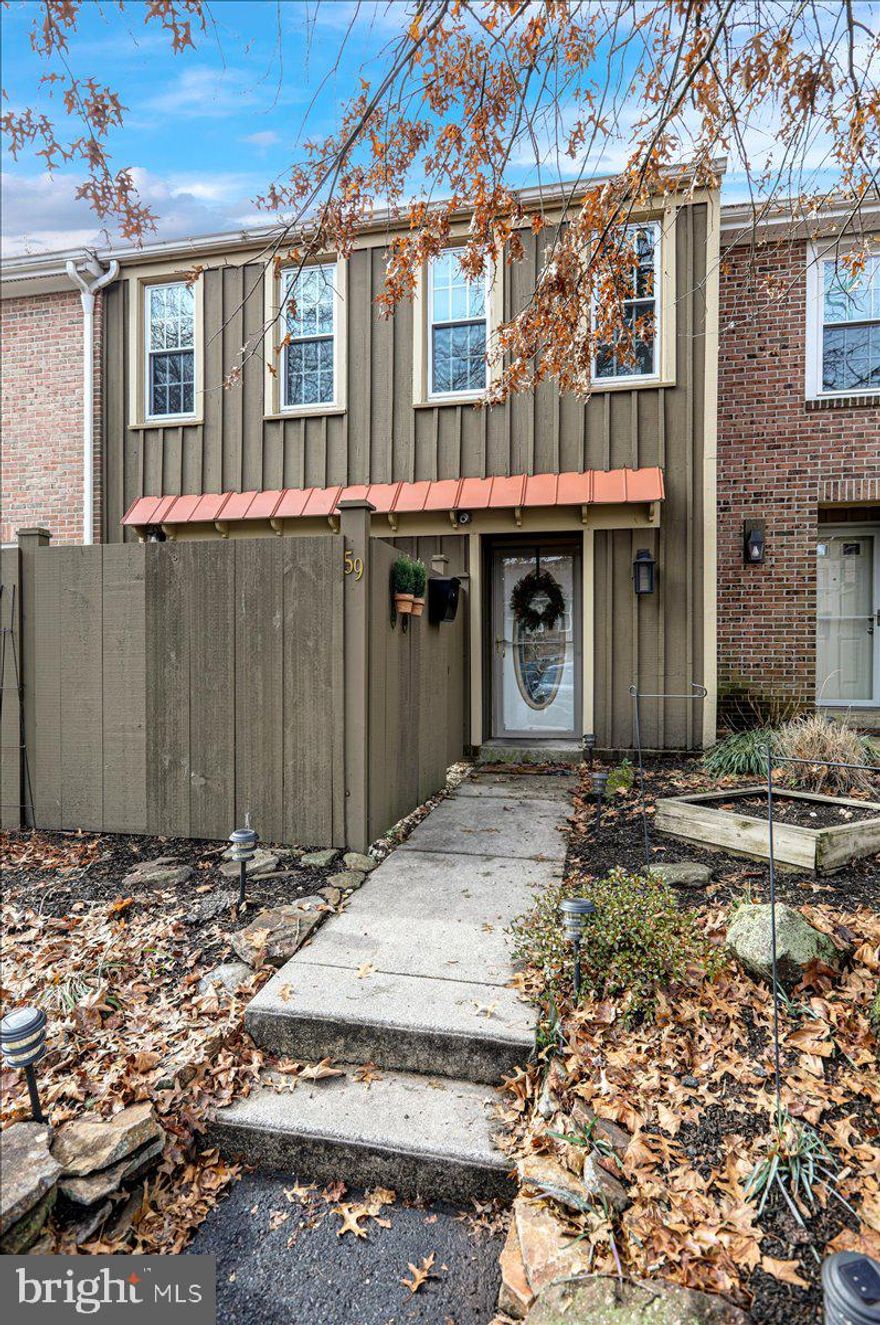 Enjoy the ease of living in this inviting open concept three bedroom,  two and a half bathroom home located at 59 Medinah Drive in Flying Hills. Recently updated, this home is filled with great features including a new roof put on in 2022. The kitchen boasts a lovely tiled backsplash, custom glass cabinets, and granite countertops. Step out from the kitchen onto a front garden area in the front of the home. The spacious living room offers a cozy brick fireplace, hardwood floors, and access to a covered patio. On the main level, you'll also find a dining area and powder room. Upstairs, there are three comfortable bedrooms, including a primary suite with a walk-in closet and full bathroom. The lower level adds an extra 260 sq. ft. of finished space, complete with a full wet bar featuring a wine cooler, and tiled backsplash. Conveniently located near highway access, Flying Hills offers a range of amenities including a community pool, tennis courts, walking paths, and an 18-hole golf course. Schedule a viewing today to see everything this home has to offer!