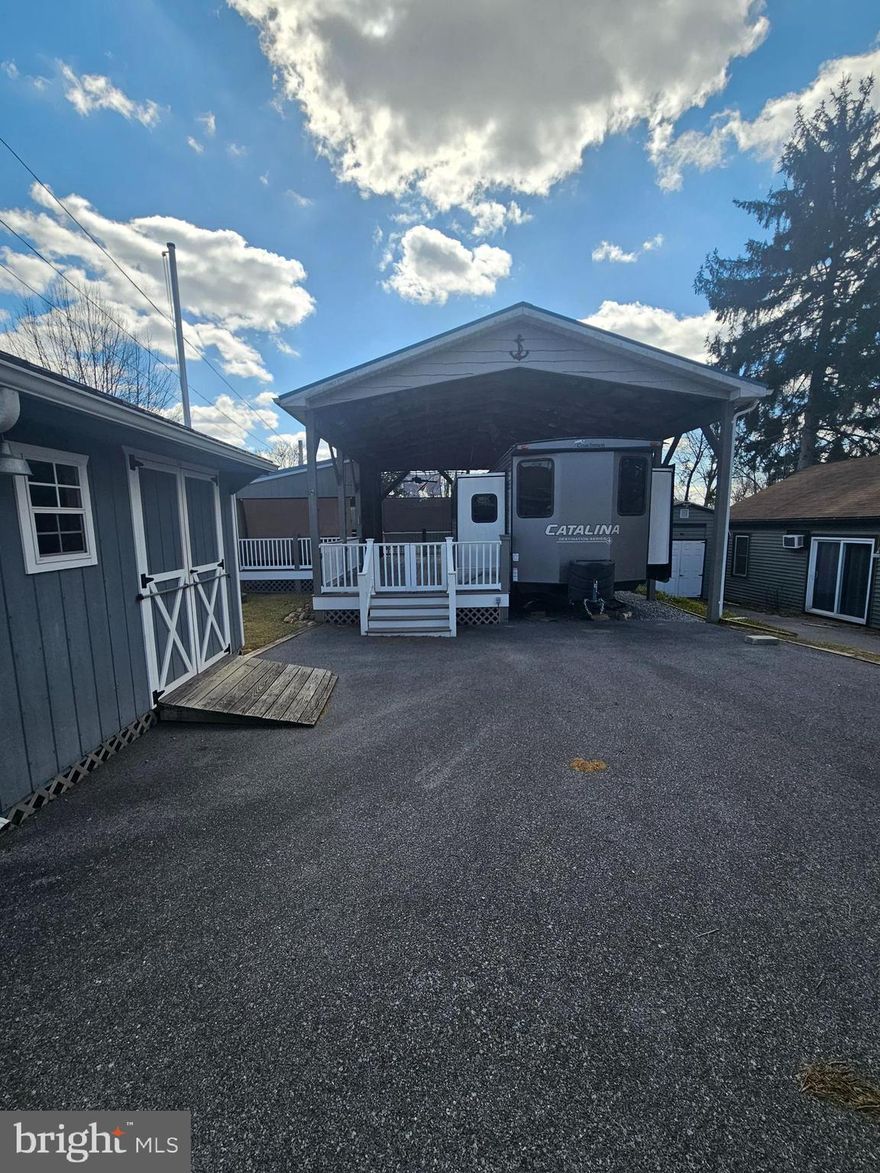 Welcome to Block 36 Lot 13 Sunshine Lane in Riverbend.  

Extremely spacious outdoor living area featuring Trex deck covered by a large enough pavilion for Rvs of all sorts. This lot is move in ready with plenty of seating for all your guests and a beautiful outdoor kitchen to chef up whatever your heart desires. There are many great memories and laughters to be had on this lot with all the people you love and peaceful enough to get the relaxation you so desire and deserve
. 
The enclosed outdoor Kitchen has hot water heater, grill, Blackstone, and other kitchen appliances. The porch has vinyl railing wrapped in chicken wire to keep your furry friends in & the rear of the deck has a sliding glass door leading to a small fenced in grassy area for pets. The Pavilion and porch has ceiling fans and electric throughout. A walk into the 2020 Catalina Coachmen Destination series (39 MKTS) feels like home and has been very well kept. Short Queen bed on one end of the camper with ample amount of storage and a pullout sofa for guests. The full kitchen is nothing short of storage and ready for your summertime living. Stop by and purchase this one today! A gold cart also fits in the shed

 Riverbend is 400 Acres of SEASONAL recreational campground full of amenities located on the Potomac River in Falling Waters, Wv. OPEN APRIL 1 - NOVEMBER 1 - This is a fun & entertaining community, yet relaxing where You own your own lot. No more renting. Make it your Home away from home.

 Approx. 10 miles of Deep water on the Potomac River access for boating, fishing & swimming. Yearly membership ($1,775) plus a $200 initiation fee for new owners, includes water, this one is on sewer, pump outs, electric, trash and the park amenities such as 3 pools, putt putt course, Horseshoe club, Boat club, Poker runs, Trick or Treat, Christmas in July, live bands, basketball court, tennis court, fireworks, car show, Church, restaurant, bar, convenience store (Great food), playground, volleyball, ball field and much much more. Bring your golf carts, water toys and come enjoy life!