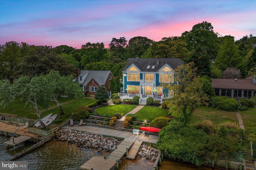 Welcome to an extraordinary waterfront retreat that epitomizes coastal living at its finest!  Behold the awe-inspiring open water views of the majestic Chesapeake Bay and look out from the 130-foot pier onto Gibson Island, the Baltimore Harbor Lighthouse, and the Eastern Shore. The open-concept main level boasts Brazilian cherry wide-plank wood floors, beautiful custom stonework, and soaring ceilings that merge flawlessly together to create a luxurious living space, and the thoughtful design features expansive floor-to-ceiling windows at every turn to maximize the picturesque water views. Built for true gourmet cooking, the kitchen features a custom patina copper range hood, a state-of-the-art six-burner gas stove, custom quartz countertops, double ovens, food warmer, cabinet-style sub-zero refrigerator, and a prodigious 7’ x 4’ solid cherry wood island.  An additional 7’ x 4’ quartz-topped island complete with a wet bar, ice maker, and wine cooler, affords perfect entertaining. Elevate your dining experience in the formal dining room, adorned with custom stone arches that frame an alluring vista of the waterfront family room. The main floor also features an elevator that effortlessly transports you to all three levels, a desirable first floor bedroom with an ensuite bathroom, and a private office with custom built-ins and French doors that open to a serene rock garden. A wide wood staircase leads upstairs where you are greeted by a second family room with a stone gas fireplace flanked by light-filled windows. Truly magazine worthy, the primary suite boasts 14-foot custom-washed pine ceiling, sitting room, three-sided gas fireplace, and private sunroom leading to a waterfront balcony. Breathtaking water views by way of floor-to-ceiling windows make the primary suite a veritable pièce de résistance. This sanctuary also boasts a breakfast bar with sink, microwave and refrigerator for easy mornings, two expansive walk-in closets, dedicated 2nd laundry room, and a dressing area with a built-in vanity. The lavish bath includes a two-person jacuzzi with a gas fireplace above, heated tile flooring and large steam shower to unwind in ultimate luxury.  Two meticulously appointed bedrooms with walk-in closets and ensuite bathrooms complete the upper level. Watch the big game or host a party in the spacious lower level, complete with a recreation room, an enormous storage room, cedar walk-in closet, and a large ensuite bedroom.  Step outside where a realm of relaxation and entertainment awaits: a covered lanai, six-person jacuzzi ( 2022), and a sprawling 40’ x 12’ deck, is perfect for hosting! The 130-foot pier, reconstructed in 2021, boasts power and water connections and is equipped with a remote-controlled boat lift capable of accommodating 12,500 lbs., as well as an 1,100 lbs. jet ski lift. For the water enthusiasts, a kayak launch awaits on the 70-foot waterfront sundeck, with a restored rip rap in 2021. As night falls, the property transforms into a mesmerizing spectacle with its custom landscape and house lighting, illuminating the impeccably designed and maintained gardens. An extended paver driveway with extra parking, garage workshop, house generator, and striking new regatta blue siding are just icing on the cake of this one-of-a-kind forever home. Zoned to the coveted Broadneck school district and also a short distance to the best local neighborhood shopping center with many family-owned shops and restaurants. Also located close to the mouth of the Magothy River with several dockside restaurants and fuel docks! Don't miss the chance to make this yours- life on the water makes every day a dream vacation!