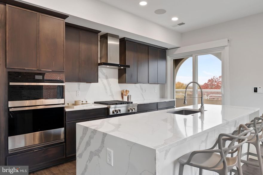 Newly repositioned penthouse residence in the heart of Old Town North, Alexandria offering a rare private terrace and sweeping DC skyline views.
Located in the boutique Towngate North building, Penthouse 402 blends modern design with effortless indoor-outdoor living just minutes from the Old Town waterfront, King Street, Washington DC, and Reagan National Airport.
The home features an expansive open layout anchored by a chef’s kitchen with an Italian quartz waterfall island, JennAir appliance suite, custom cabinetry, and designer lighting throughout. Floor-to-ceiling windows frame dramatic city views while filling the living spaces with natural light.
A standout feature of this residence is the approx. 363 sq ft private terrace, creating a true extension of the home—perfect for entertaining, outdoor dining, or enjoying sunset views of the DC skyline and Potomac River corridor.
The spacious primary suite offers a spa-inspired bath and generous closet space, while additional bedrooms provide flexibility for guests, a home office, or secondary living.
Originally converted to luxury residences in 2022, Towngate North offers modern boutique living in one of Alexandria’s most vibrant neighborhoods. Residents enjoy easy access to the Old Town waterfront, Amazon HQ2, National Landing, Washington DC, and DCA, making this an ideal primary residence or lock-and-leave pied-à-terre.
A rare opportunity to own one of Old Town North’s premier penthouse residences with private outdoor space and skyline views.