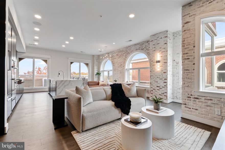 Newly repositioned penthouse residence in the heart of Old Town North, Alexandria offering a rare private terrace and sweeping DC skyline views.
Located in the boutique Towngate North building, Penthouse 402 blends modern design with effortless indoor-outdoor living just minutes from the Old Town waterfront, King Street, Washington DC, and Reagan National Airport.
The home features an expansive open layout anchored by a chef’s kitchen with an Italian quartz waterfall island, JennAir appliance suite, custom cabinetry, and designer lighting throughout. Floor-to-ceiling windows frame dramatic city views while filling the living spaces with natural light.
A standout feature of this residence is the approx. 363 sq ft private terrace, creating a true extension of the home—perfect for entertaining, outdoor dining, or enjoying sunset views of the DC skyline and Potomac River corridor.
The spacious primary suite offers a spa-inspired bath and generous closet space, while additional bedrooms provide flexibility for guests, a home office, or secondary living.
Originally converted to luxury residences in 2022, Towngate North offers modern boutique living in one of Alexandria’s most vibrant neighborhoods. Residents enjoy easy access to the Old Town waterfront, Amazon HQ2, National Landing, Washington DC, and DCA, making this an ideal primary residence or lock-and-leave pied-à-terre.
A rare opportunity to own one of Old Town North’s premier penthouse residences with private outdoor space and skyline views.