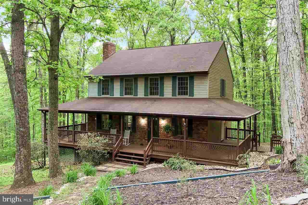 Wooded Country views surround this 3BR, 2.5 BA Colonial. Wrap around porch for your enjoyment on the outside. Open floor plan w/lots of natural light on the inside w/hardwood floors thru-out the first floor and new carpet upstairs. French doors from Mstr BR goes to balcony. Upgraded master bath. Walk-out bsmt w/partially studded walls & rough-in ready to be finished. Updated electric 200 amp. Don't miss this one!!!