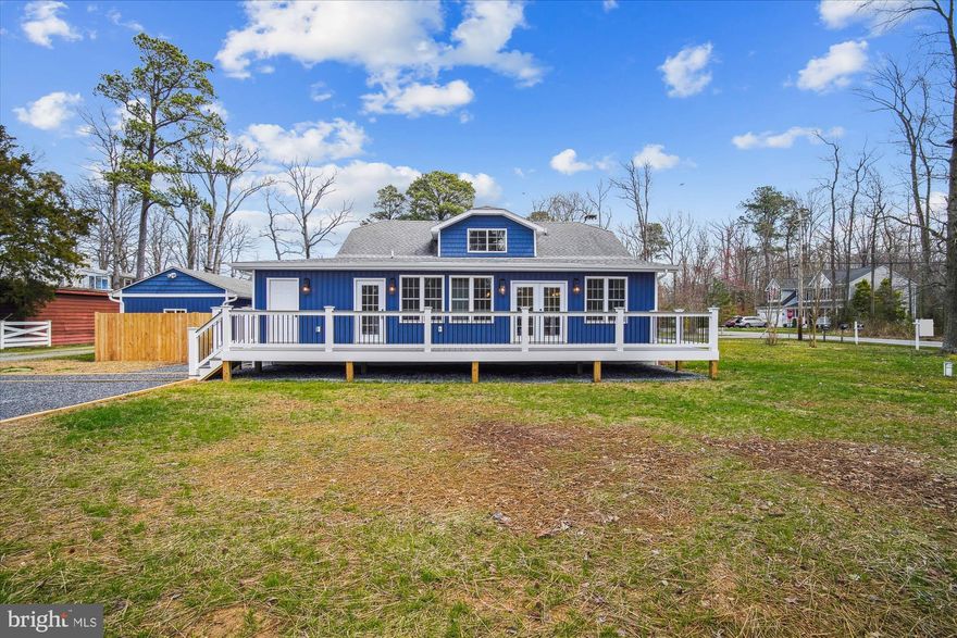 Welcome to North Beach Park! 2023 Custom Built Cape Cod on Corner Lot with 3 Bedrooms and 2.5 Baths. Water Views from the Bedrooms, Wide Panel LVP Flooring Throughout, and almost 2300 sq ft of Fully Remodeled Living Space. Modern Gourmet Kitchen with Quartz Countertops, White Shaker Cabinetry, Oversized Island with Farmhouse Sink, GE Profile Collection Kitchen Appliances, and Dry Bar with Wine Fridge. The Dining and Living Room Blend Seamlessly with the Traditional Crown Molding Cased Doors and Windows. Two Main Level Bedrooms Thoughtfully Connected by a Jack and Jill ensuite Bathroom. Other Main Level Features include the Laundry Room outfitted with GE Profile Collection Washer/Dryer, Cabinets, Sink, and Butcher Block Countertop and a Wood Burning Fireplace.
This Charming Cape Cod Boasts a Cozy Upstairs Bedroom Retreat, complete with an ensuite Full Bathroom and ample Closet Space. Outdoors you will Love the Low Maintenance Composite Deck and Detached Garage. Plenty of Parking for all your Guests with the Huge Parking Pad. Coveted Flat and Cleared Lot with .36 of an Acre. 1 Block to the Bay, Moments Away From Herrington Harbor Marina, North Beach Boardwalk/Pier, Restaurants Shops. Experience the Epitome of Coastal Living with easy access to Waterfront Activities such as Sailing, Kayaking, and Sunset Strolls Along the Shore. 
Open House 3/16, Saturday 11AM-1PM.