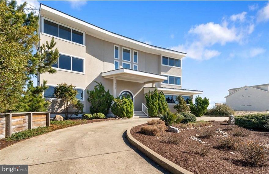 Step into the epitome of coastal living with this extraordinary custom-built, 1-owner home on the oceanfront. With soaring ceilings and walls of glass, the design blends natural light with panoramic ocean views, offering an unparalleled sense of space and tranquility just steps to the ocean. Constructed with the highest quality steel and concrete, this bulkheaded home is the ultimate in durability and style: perfect as a solid beach getaway or a luxurious family residence. Every corner speaks to craftsmanship and attention to detail, making it the perfect retreat for those seeking a unique blend of sophistication and seaside serenity. Don't miss the opportunity to experience this magnificent, one-of-a-kind property!