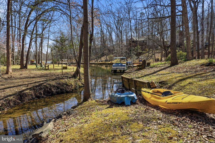 WATERFRONT LIVING on Lake Keaton in the amenity-rich, gated community of Lake of the Woods! This well-maintained 4 bedroom, 3 bath rambler with finished basement offers the perfect blend of comfort, flexibility, and scenic lake views—ideal as a full-time residence or a relaxing weekend retreat. Launch your kayak right from your backyard and enjoy peaceful mornings on the water.
Inside, the main level offers easy one-level living with hardwood floors welcoming you into the formal living room, which flows into a versatile sitting room, den, or office space. The open kitchen features Corian countertops, all appliances, abundant cabinetry, and a breakfast bar overlooking the dining area highlighted by a cozy gas fireplace.
The impressive 23x14 sunroom with vaulted ceilings and a wall of sliding glass doors fills the home with natural light and opens to an oversized deck—perfect for entertaining, cookouts, or simply relaxing while enjoying the tranquil waterfront views.
The spacious primary suite includes a private bath with jetted soaking tub and separate shower, while two additional guest bedrooms complete the main level.
The finished lower level expands the living space with a large recreation room featuring a wood-burning fireplace and wet bar, plus direct access to a covered patio/screened in porch  and your private waterfront with bulkhead and boat launch area. A large finished basement bedroom suite offers great potential for guests, extended family, or an in-law/au pair space. A separate hobby, craft, or exercise room could also serve as a 5th bedroom (NTC). Additional unfinished areas provide excellent storage or room for future expansion.
Situated on a paved driveway with an attached two-car garage, this home invites you to start making lake-living memories.
All new HVAC in 2022.
Lake of the Woods is one of Virginia’s premier gated lake communities, offering two lakes (including the 500+ acre main lake), boating, fishing, beaches, marinas, golf course, clubhouse dining, sports bar, fitness center, swimming pools, pickleball and tennis courts, equestrian center, walking trails, and year-round community events. Conveniently located approximately 15 miles west of Fredericksburg with easy access to shopping, dining, and commuter routes.
Come discover why so many people love living the Lake of the Woods lifestyle.
Seller to give purchaser a $5,000 carpet allowance with acceptable offer.  Also, there is extra laminate flooring that seller will leave for buyer.
