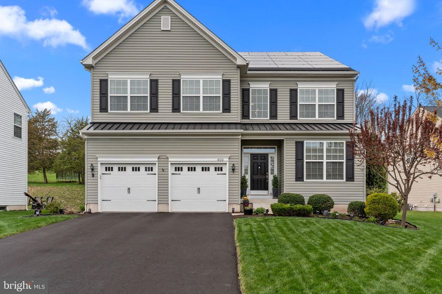 Welcome to 400 Hickory Drive, equipped with energy-efficient solar panels, significantly reducing utility costs and ensuring eco-conscious, low-maintenance living for decades. Solar panels are OWNED, not leased, and already paid in full. This stunning home in the desirable Country Ridge community of Perkasie Borough, just a short walk from trendy restaurants and boutique shopping. This beautifully maintained residence offers 4 spacious bedrooms, 3.1 bathrooms, and a sun-drenched open floor plan with upgraded light fixtures throughout. Enter through the dramatic two-story foyer into the expansive living and dining area. Around the corner in the great room, a striking two-story stone fireplace and floor-to-ceiling windows create a warm and inviting centerpiece. The gourmet kitchen is a true showstopper, featuring quartz countertops, upgraded stainless steel appliances, a chic tile backsplash, contrasting cabinetry, a spacious walk-in pantry, an oversized island, and an adjacent breakfast room perfect for casual dining. A convenient laundry room, powder room, and access to the attached two-car garage complete the main level. Step outside to your private backyard oasis, complete with a sprawling deck, fieldstone hardscaping, raised garden beds, a landscaping shed, fire pit area, and full fencing for privacy and relaxation. Upstairs, the luxurious primary suite offers a tray ceiling, large walk-in closets, and a spa-inspired en suite bathroom with dual vanities, a soaking tub, a walk-in shower, and a private water closet. Three additional generously sized bedrooms with ample closet space share a well-appointed hallway bathroom. The finished lower level adds even more living space, boasting a built-in home theater with projector and screen, an expansive open area perfect for entertaining or flexible use, a full bathroom, and two large rooms dedicated to storage and mechanicals. Located within the award-winning Pennridge School District, this turnkey home truly has it all—style, comfort, and an unbeatable location. Schedule your private showing today!