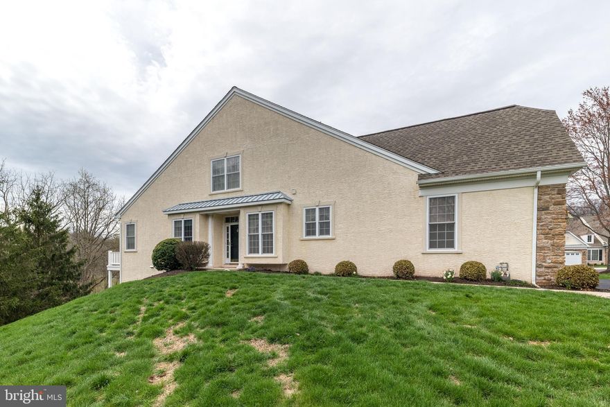 End unit located in Harrington Village, a 55 and over community, on the most desirable lot backing up to open space and woods with a walk out basement.   Beautiful and well cared for home with a private side entrance.   The upgraded kitchen features stainless steel appliances, granite counters, tile floors, tile backsplash, pantry and lovely breakfast area.  The open floor plan has a living / dinning room which flows to the family room with a vaulted ceiling and sliders opening to the private maintenance free deck with a retractable awning providing private open and wooded views.  The spacious first floor master bedroom has two walk-in closets.  The recently remodeled master bath has radiant heated tile floors, double sinks with granite counters, and a large walk-in tile shower with glass doors. There is an additional bedroom, hall bath and laundry room completing the first level.   The second level has a loft overlooking the family room, 2 additional bedrooms or hobby rooms and a hall bath.  The clean, full walk out basement is ready for all your storage/hobby needs or could be finished for additional living space.  Completing your new home is a two-car front entry garage.   This sought after community has walking paths, lovely landscaping and a community club house with kitchen, gathering rooms, exercise room and game room.   Welcome Home!