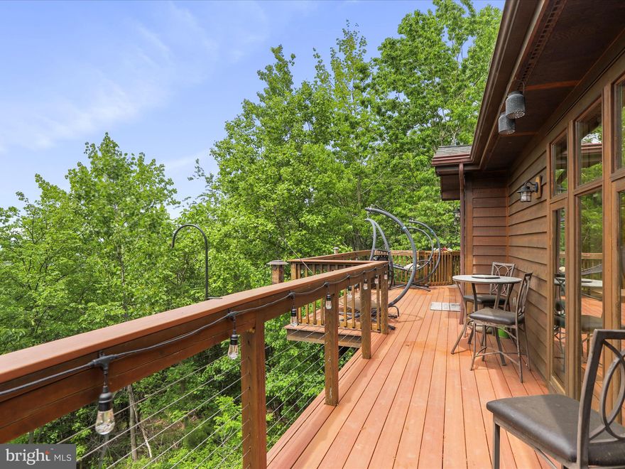 REDUCED $50,000!! PRICED TO SELL! Watch amazing sunsets and The Northern Lights from your 2-story deck high atop towering trees! Overlooking Charles Town, WV, with seasonal views of the Shenandoah River. This custom-designed Lindal Cedar Home “Bungalow” series is located near the town of Harpers Ferry, WV,  only 5 minutes from the VA state line, 25 minutes from Leesburg, VA, and just steps from the Appalachian Trail. This is the perfect mountain retreat or full-time home for all nature lovers. Breathtaking views change throughout the seasons, each one different than the last. 

The contemporary-style home consists of many windows and vaulted ceilings for an open atmosphere feeling. Indoors you’ll find a gas fireplace, fully equipped kitchen, pantry, hardwood floors, tile floors, and sweeping views at every turn. The main-floor owner's suite has an ensuite bath with a 2-person jetted tub, a large walk-in closet, and vaulted ceilings. There’s a door leading out to the deck for experiencing a peaceful place to enjoy your morning coffee while watching abundant wildlife. Also on the main level there’s a study off the living room in the main part of the house with tall windows and more views. The laundry room is just off the owner's suite (washer & dryer included) and leads to the oversized 2-car garage. The lower level also has large windows, exposed wood beams, an additional family room, and two more generously sized bedrooms. On this level is the 2nd full bath with 2 vanities and a jetted tub. All three of the rooms on this level open to the private lower deck. There is a sub-basement with exterior access only and a gravel floor for storage that has 6' clearance in the entire footprint of the home. Outside there’s an Amish-style shed, a chicken coop, a stamped concrete patio, and several raised beds for gardening. There are several fenced-in areas to keep your puppies safe. There are also doggie doors throughout the house so they can come in or out at their leisure. In addition, there is a new HVAC system and a new gas tankless hot water system. No worries if the power goes out; there is a 20W whole-house generator to keep things running. Seller is leaving due to an employment relocation or she would stay forever. Come experience nature at its finest. Schedule your private showing today.