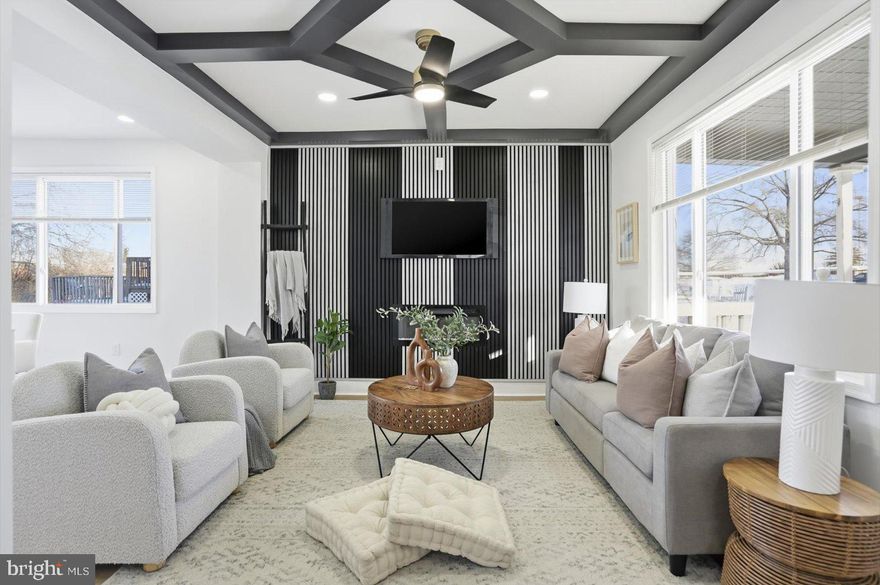 Step into this beautifully designed 3-bedroom, 3.5-bathroom home where custom details and modern style shine at every turn. The living room makes a striking first impression with a gorgeous accent wall, large windows, and an abundance of natural light, all enhanced by custom ceiling molding and stylish, contemporary light fixtures throughout the home.

The kitchen features stainless steel appliances, a custom backsplash, a spacious island perfect for gathering, and custom under-cabinet lighting that highlights the thoughtful craftsmanship and attention to detail. Every space feels intentional, warm, and elevated.

The primary bedroom offers a private retreat complete with its own well-appointed bathroom, while the lower level includes a full bathroom, adding flexibility for guests or additional living space. Outside, enjoy an inviting front porch and a spacious, fenced-in backyard—ideal for entertaining, relaxing, or play.
This home is filled with character, comfort, and high-end finishes, offering a perfect blend of functionality and contemporary design.