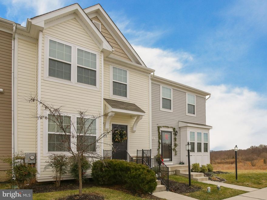 This almost-new 2 level townhouse in Fairfax Crossing overlooks open space and has gorgeous views of the mountains.  With a FULL 3-level 8 foot bumpout, the kitchen/family room/dining area is open and roomy.  The adjoining living room on the same level offers space for the whole family and a level of separation as well.  The oversized master suite has an ensuite bath with a soaking tub, walk-in closet, and mountain views.  Two additional bedrooms and bathroom are also on this level. The unfinished, but very clean basement provides extra living space and lots of storage.  This house is in wonderful condition- ready to move in and you don't even need to paint!  The location close to commuter routes, but on a culdesac street, allows for privacy while being near everything!  With so much room and a gorgeous view, this house is a must-see!