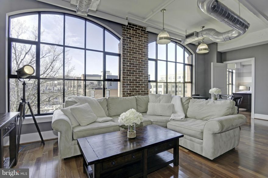 Stunning, rarely available W & M loft w/floor-to-ceiling windows & private roof deck w/western views. Gourmet kitchen w/granite counters & SS appliances incl. SubZero refrigerator & Wolf gas range. Master bedroom boasts custom walk-in closet & luxurious en-suite bath w/glass shower. HWF, loft w/Murphy bed, storage bin, & 1 garage parking space. Pet friendly, pool, fitness center, 24hr concierge.