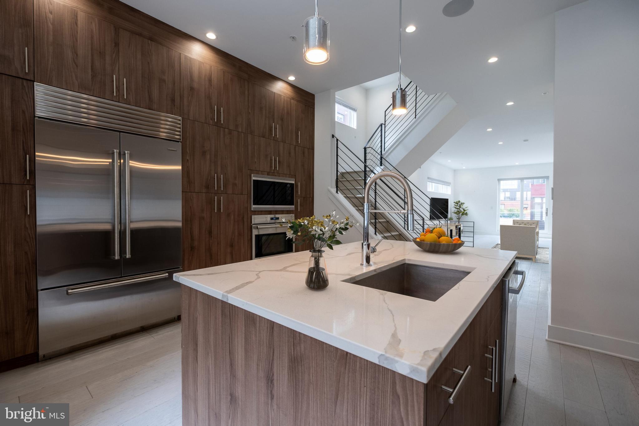 Welcome to this stunning, contemporary CORNER HOME located in the heart of SOCIETY HILL. Offering a rare blend of luxury, functionality, and convenience. This residence, with hardwood floors throughout, features FIVE SPACIOUS BEDROOMS, FIVE FULL BATHROOMS, and two powder rooms, along with two dedicated office spaces and three separate living areas—making it the ideal layout for both entertaining and working from home. Enjoy the ease of city living with a private elevator and a TWO-CAR GARAGE.
From the moment you enter, you'll notice the beautiful craftsmanship and attention to detail throughout. Highlights include: a custom staircase, a sleek interior metal handrail system, and beautiful windows that flood the space with natural light. The chef’s kitchen is a true showstopper, equipped with high-end appliances, abundant cabinetry, generous counter space, and a large center island with additional seating. Adjacent to the kitchen, the open dining area seamlessly flows into a sunlit living room with access to one of the home’s FOUR PRIVATE OUTDOOR SPACES.
This home offers incredible versatility with TWO ADDITIONAL OFFICE OR DEN SPACES that can be tailored to suit your lifestyle—whether for remote work, fitness, or creative pursuits. A FULLY FINISHED BASEMENT adds even more living space, ideal for a media room, guest suite, or play area. Each of the five bedrooms is generously sized, and several feature en-suite bathrooms. The luxurious primary suite serves as a personal retreat, complete with a spa-inspired bathroom offering a SOAKING TUB, beautifully tiled glass shower, and dual vanities, along with a large walk-in closet.
Outdoor living is elevated by the MASSIVE ROOF DECK with sweeping views of the Ben Franklin Bridge, Delaware River, and Center City skyline—perfect for entertaining or relaxing in your private urban oasis.
Perfectly situated just steps from historic streets, acclaimed restaurants, parks, and Jefferson and Pennsylvania Hospitals, this one-of-a-kind home truly has it all—SPACE, VALUE, STYLE, AND LOCATION.