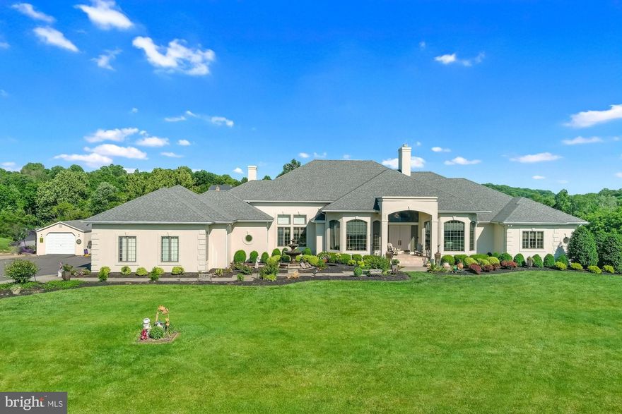 Stunning. Stately. Sprawling rambler is the perfect blend of contemporary and classic.  A grand foyer welcomes you into a sunken living room with a wood burning fireplace and a sweeping bucolic view under vaulted ceilings.  Generous fenestration provides an abundance of natural light.  This home is exquisitely built with thoughtful consideration.  It is the perfect place to live, relax, and play.  Gorgeous gourmet kitchen features premium cabinetry and granite countertops, top-of-the-line appliances, and a Butler’s pantry.  The north end of the home has three bedrooms.  The expansive primary suite features a kitchenette, balcony access, walk-in closets, an exercise room, and 2 full baths, including double vanities and a jetted soaking tub with a panoramic view. The south end of the home has a bedroom suite with a kitchenette, full bath, and access to a private patio.  The lower level is effectively a second home with 1-2 bedrooms, 1.5 baths, a lounging area, a full kitchen, recreation room, full wet bar complete with ice maker and a commercial beverage cooler. Easy access to the rear patio and the hot tub.  This custom-built home in exclusive Lambourne Downs has it all! Too much to tell here and pictures don't do it justice.  Schedule a private showing today to envision your perfect use of this rare space.