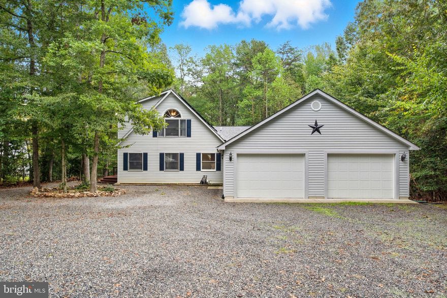 You won't want to miss this private custom designed 3 bed 3 bath lake home on the public side of Lake Anna that sits on a private cul-de-sac just minutes from the water with its own deeded boat slip!  If you are looking for a home that offers serenity and lake life this may be the one. Sitting on over 3.2 acres with a large extended 30 x 40 garage in Tall Pines community this house is a site to see. Open concept interior with large windows and tons of natural light. 2 Main floor bedrooms and two main floor bathrooms its perfect for guests or family with a large loft (3rd) bedroom and third bathroom upstairs. The primary suite also has a custom designed walk in closet and private bathroom. Wood floors throughout and cozy living room with real wood burning fireplace. Stainless Steele Appliances in the kitchen and main level laundry/mud room area with built in shelving. Walk out onto your large wrap around deck and enjoy your morning coffee. 10x12 storage shed in the back and upfront you have plenty of room for parking with a huge oversized garage that is over 1200Sqft and has lots of room for several boats & lake toys. Solar Panels on the house are paid off and PEARL certified so free bonus energy and electric savings at NO cost to you!... Plus you get a BONUS deeded covered Boat Slip with Solar Lift!  Short term rental are allowed. Great lake location close to marinas, dining by boat and just a short drive to groceries and more! This community offers great common areas with a boat ramp, beach area, volleyball, horseshoe pit, two gazebos, grills, and picnic tables. This is also a golf cart friendly community. Come and tour this lake home today before its gone!