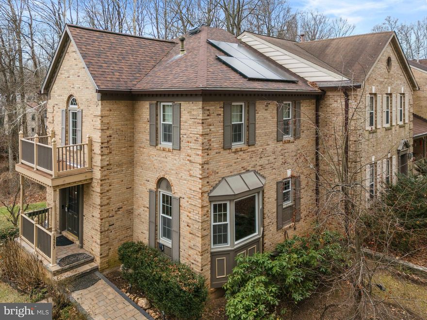 Discover the rare combination of townhome convenience and single-family character. This distinguished brick end-unit is a masterpiece of architectural detail, featuring a welcoming front portico and an elegant Juliet balcony. Surrounded by the serene beauty of Montgomery County Park Land on both the front and back, this home offers a sense of presence and charm usually reserved for detached estates!

Step inside the dramatic two-story foyer featuring a grand circular staircase and a sparkling chandelier. The unique floor plan is designed to feel like a detached home, highlighted by fine touches such as geometric arches, classic wainscoting, dentil crown moldings, and stunning hardwood floors throughout the main and upper levels.

The recently updated gourmet kitchen is a showstopper, featuring stainless steel appliances, BOSCH gas cooktop and double ovens, granite counters, kidney-shaped island and custom Armstrong cabinetry! A generous breakfast area with a bay window overlooking the peaceful front nature preserve completes the space.

Upstairs, you will find 3 bedrooms and 2 full bathrooms, both renovated in 2020 with custom tile work and high-end fixtures, including shower panel systems. The primary suite features hardwood floors, a large walk-in closet with custom built-in shelving and an updated en-suite.  Two additional generous bedrooms -one finished in hardwood and the other in LVP- luxury vinyl plank, boast ample closet space and serene nature views. 

The finished, walk-out lower level offers a large rec-room with a cozy gas fireplace and LVT- luxury vinyl tile flooring, renovated full bathroom, laundry area and ample storage. Sliding glass doors lead you to a picturesque brick patio and a private backyard that transitions directly into the county preserve.

This former model home has been meticulously maintained and updated for peace of mind: Owned Solar Panels - installed 2023, for significant energy savings; Architectural roof (2017); Updated gutters with leaf filter guards (2025); All bathrooms (2020); Thompson Creek replacement windows throughout with transferable lifetime warranty; Walkway (2023); Custom Hunter Douglas window treatments, and so much more! 

Nestled in a lovely, tree-lined neighborhood, just steps away from Paint Branch Trails. 

Enjoy easy access to major commuter routes (ICC, I-495, Rt. 29), Metro, as well as nearby shopping and dining.

2 assigned parking spaces included - directly in front of the property as well as visitors parking! *Select photos are virtually staged